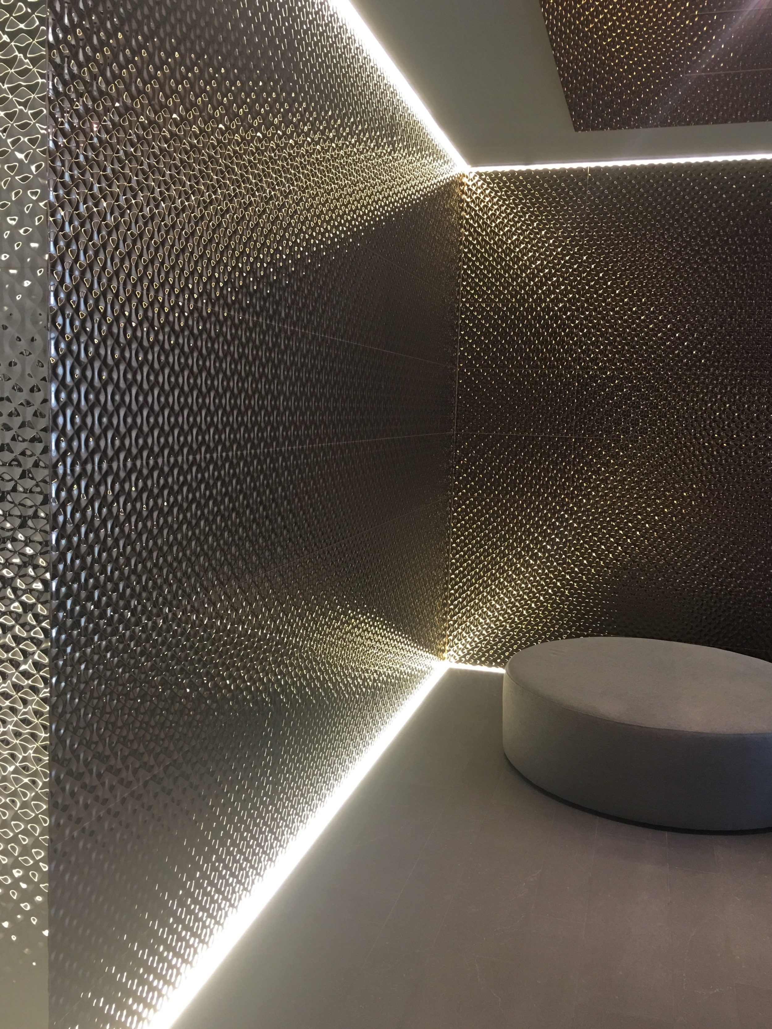 Striking geometric wall tile, with recessed lighting to highlight the design features