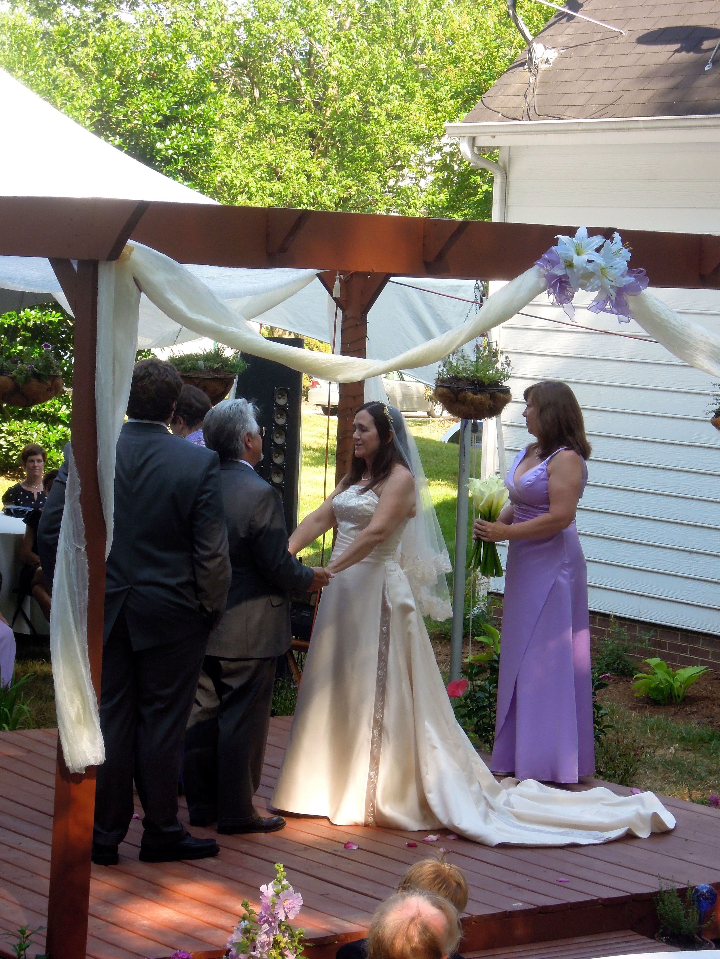 Kelly and David built a gazebo for their backyard just for the wedding surrounded by their families and friends. 