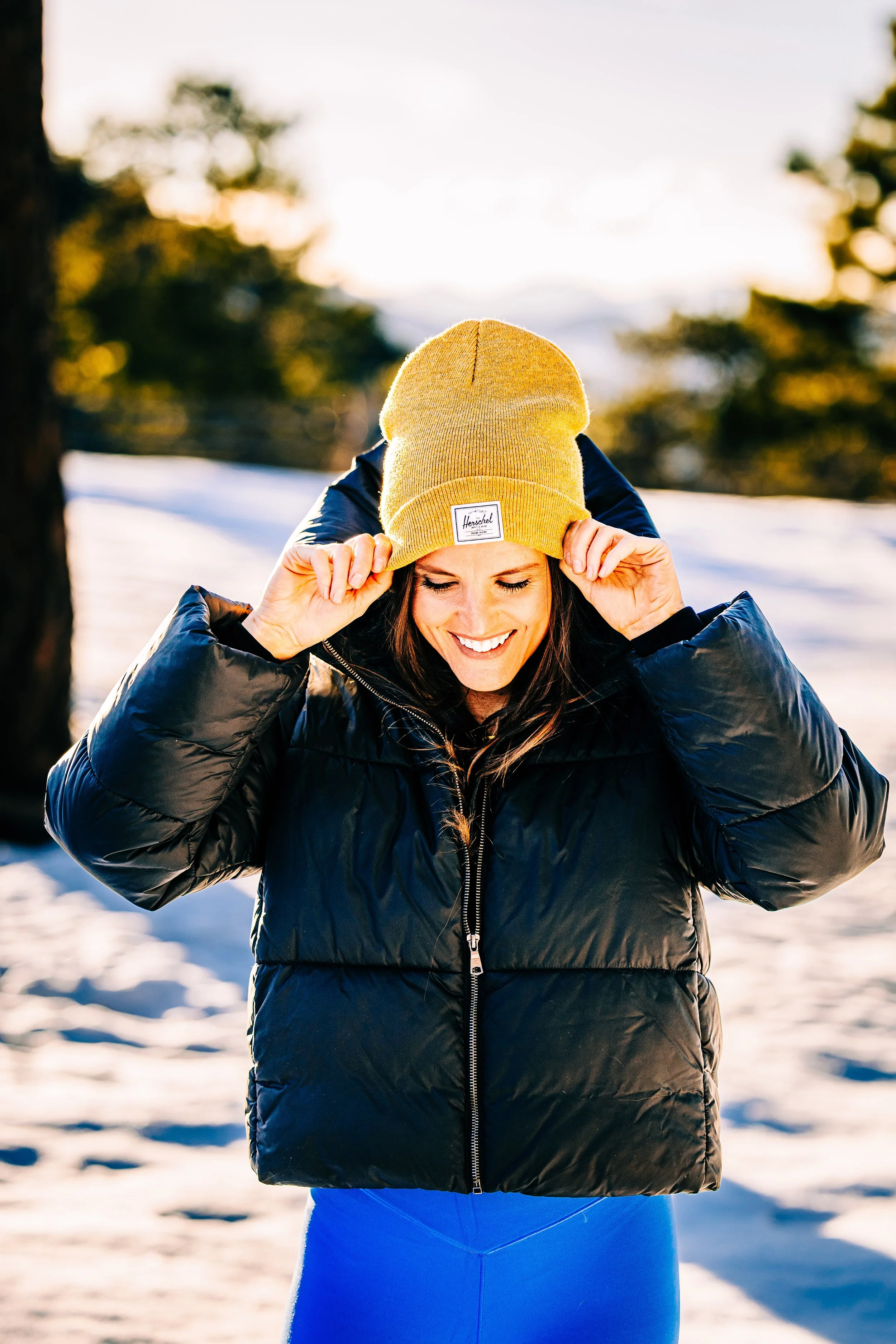 model in snow with herschel hat