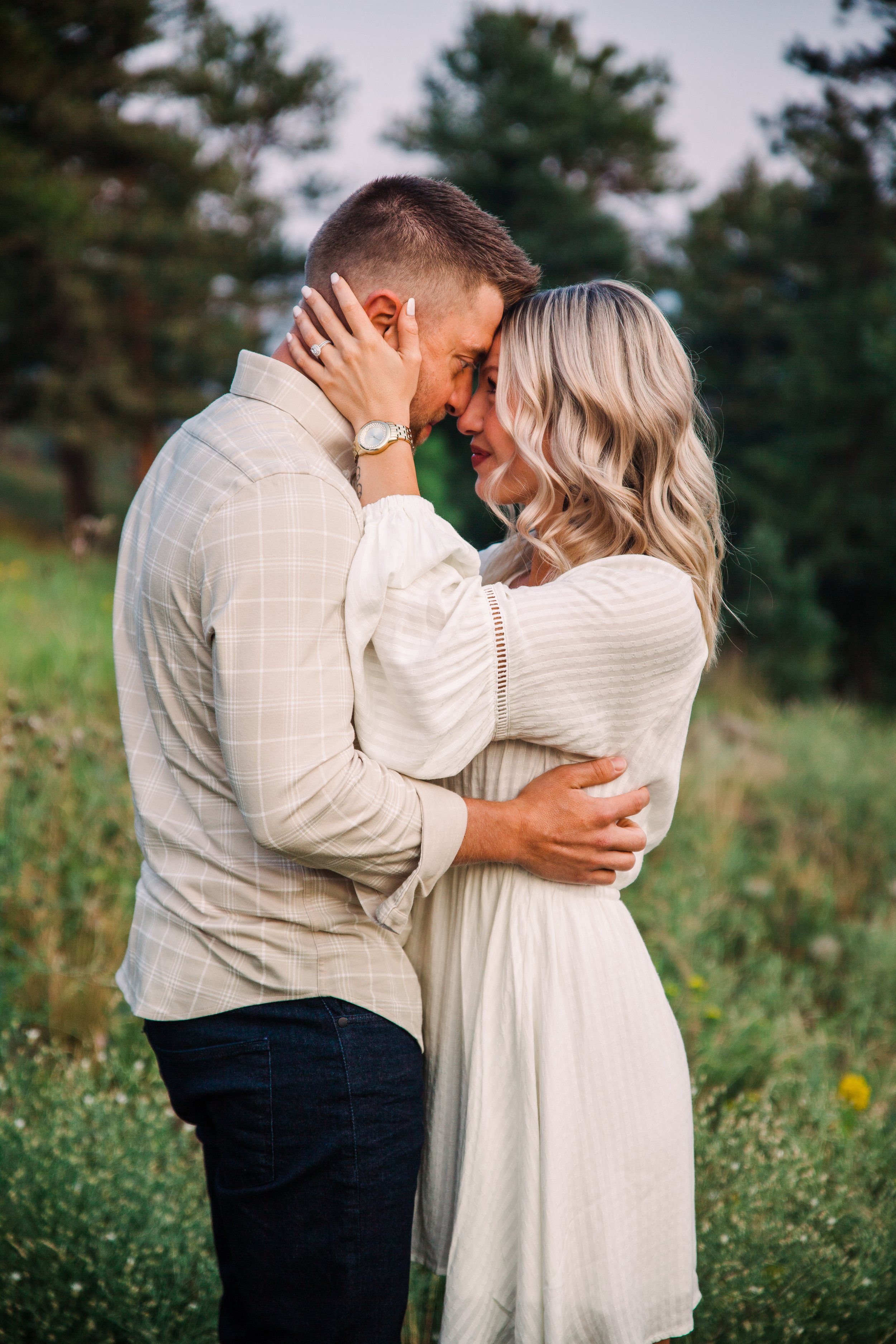 Couple kissing on hillside