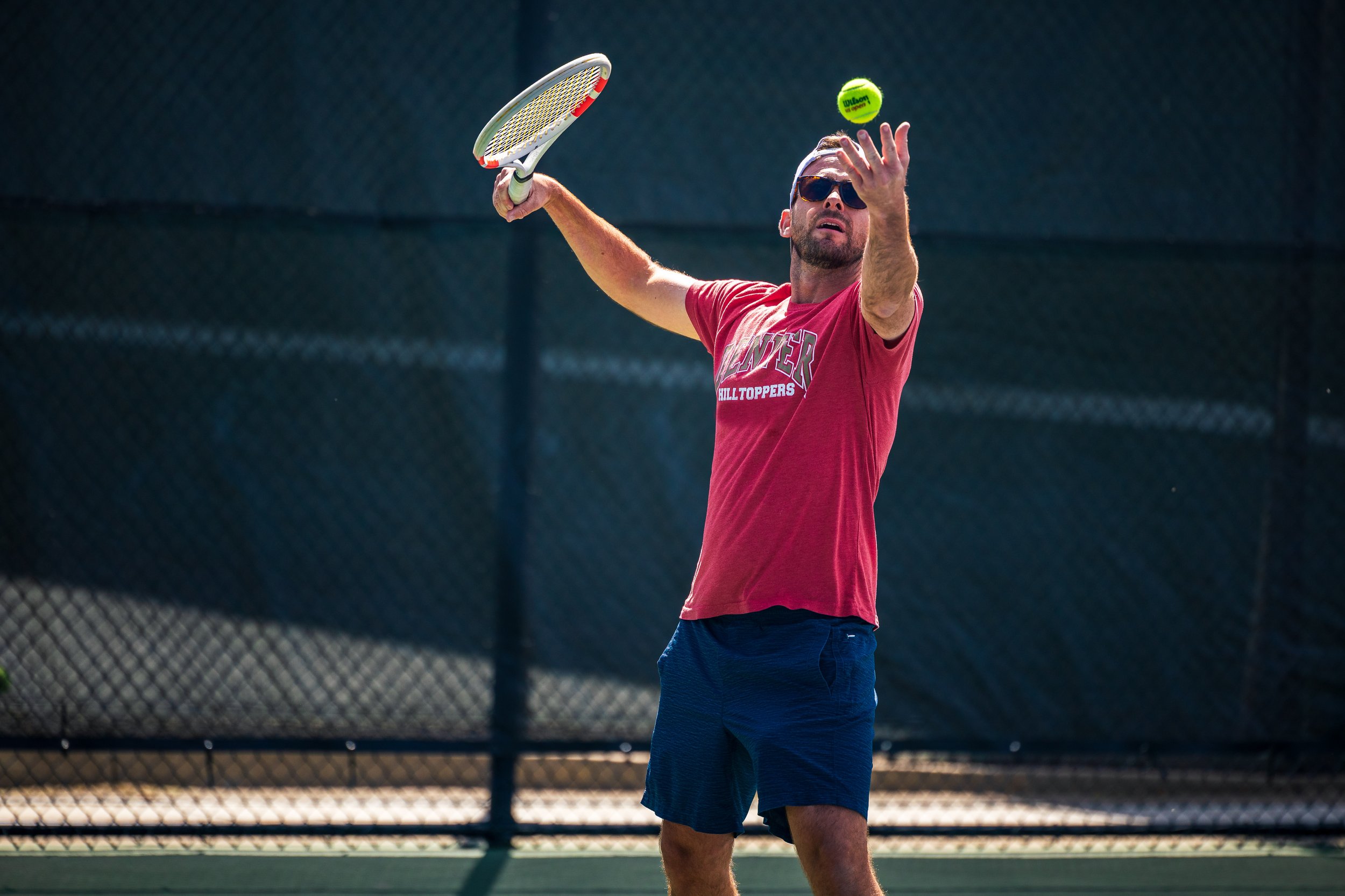 man playing competitive tennis fitness wellness denver