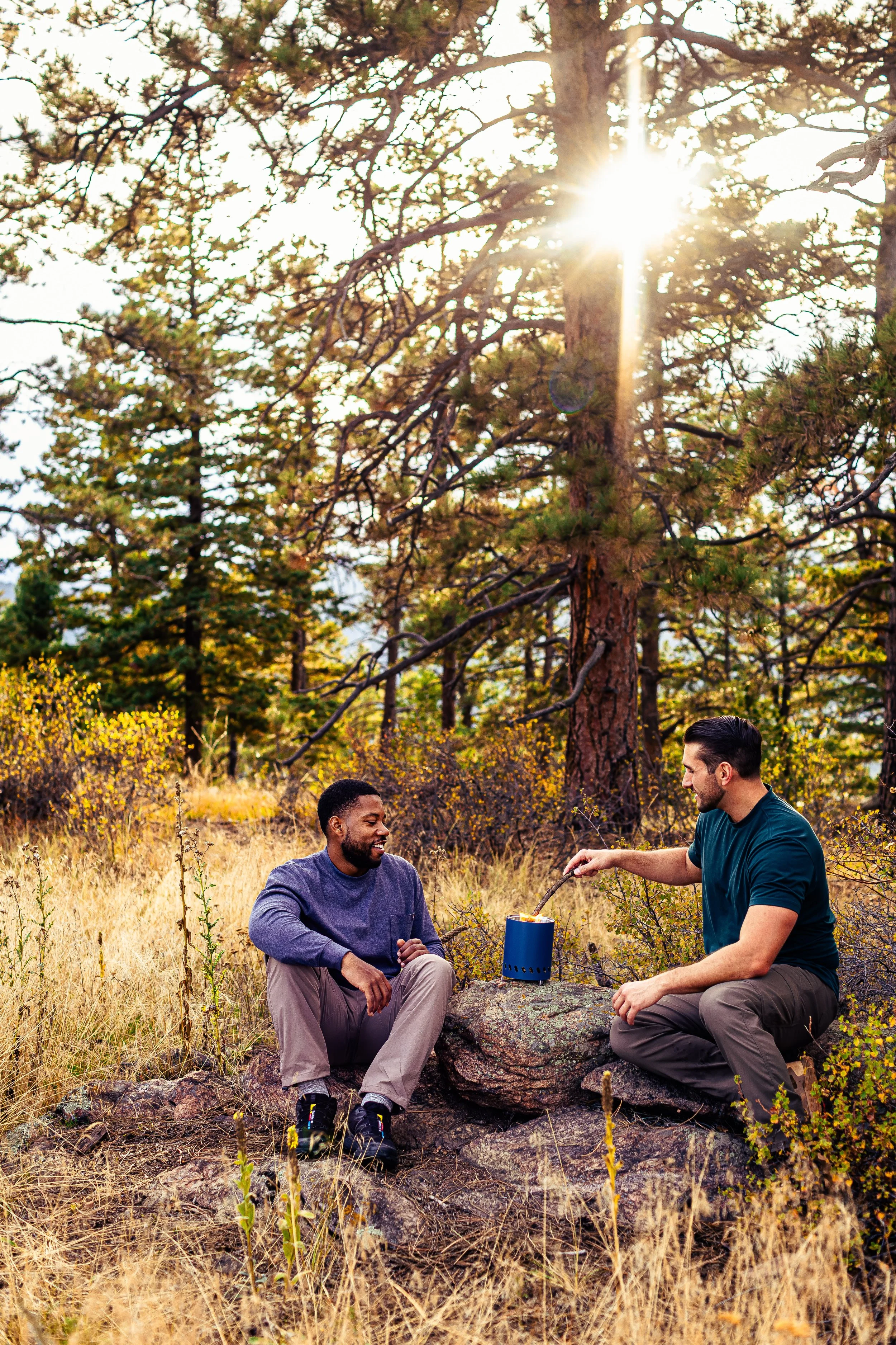 two men camping in fall colorado mountains stove
