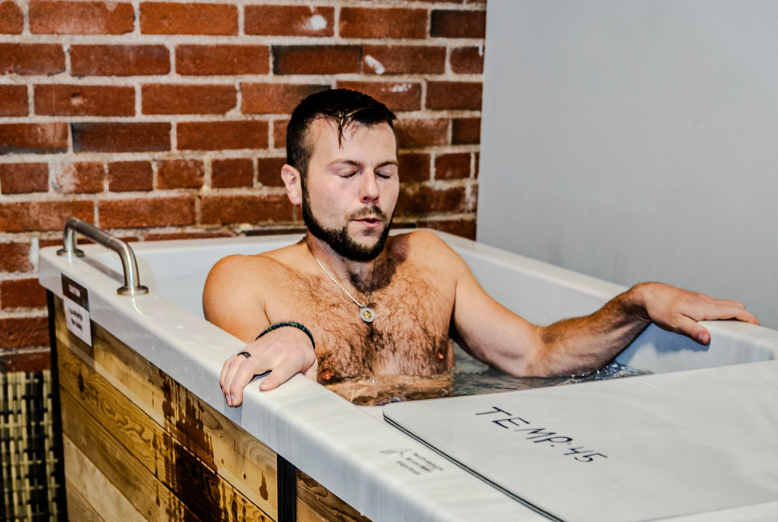 man in cold plunge fitness wellness denver