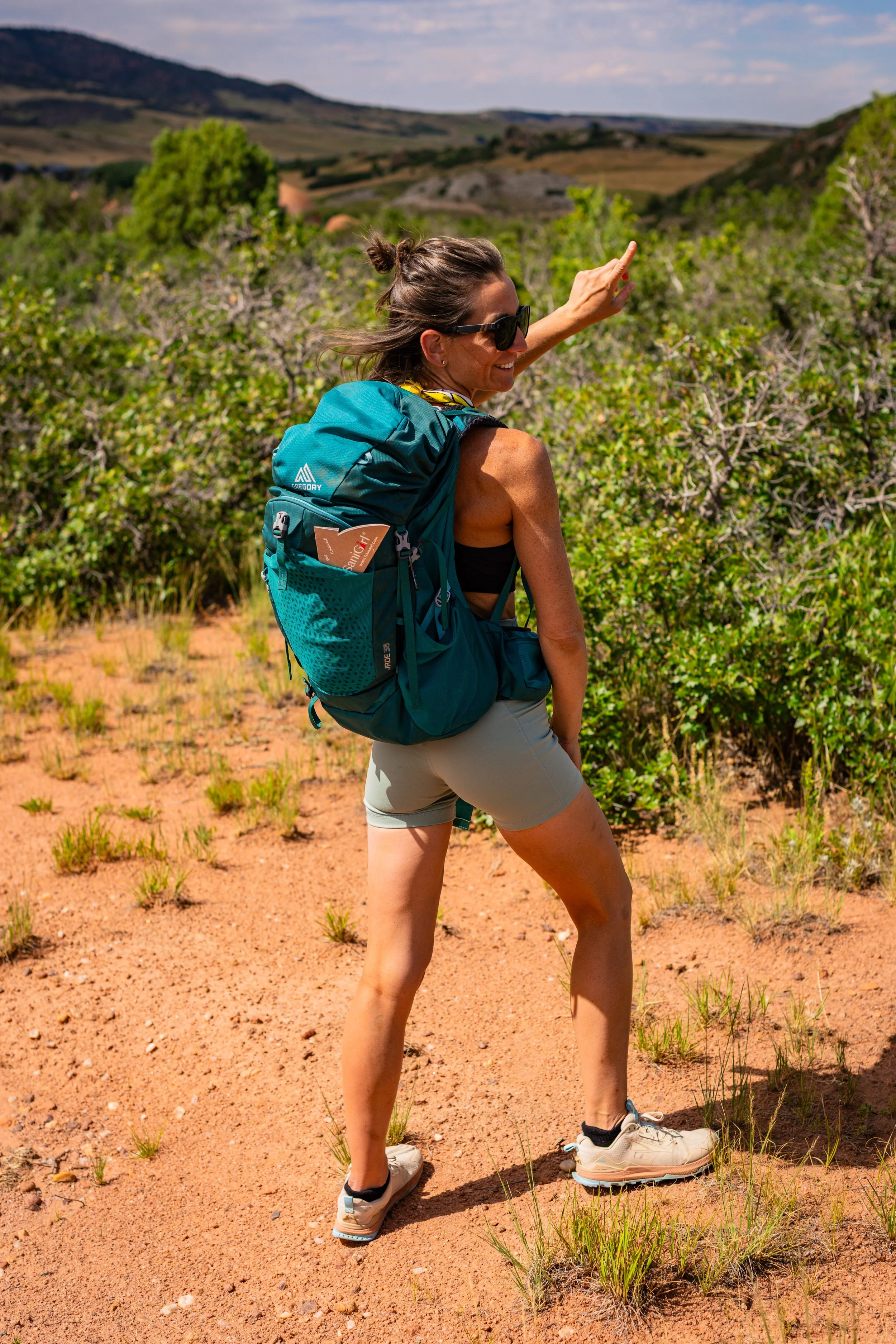woman with backpack on red rocks colorado