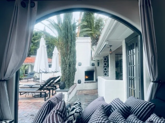 The colonnade frames a view to the outdoor fireplace