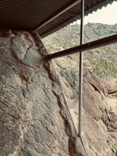 The glass abuts the boulder to blur the boundaries between indoor and outdoor spaces