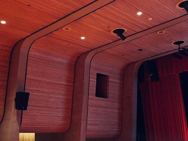 The wood slats contour the curve of the ceilings and wall