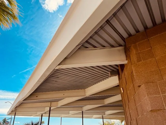 The steel frame hovers beyond the concrete block supports
