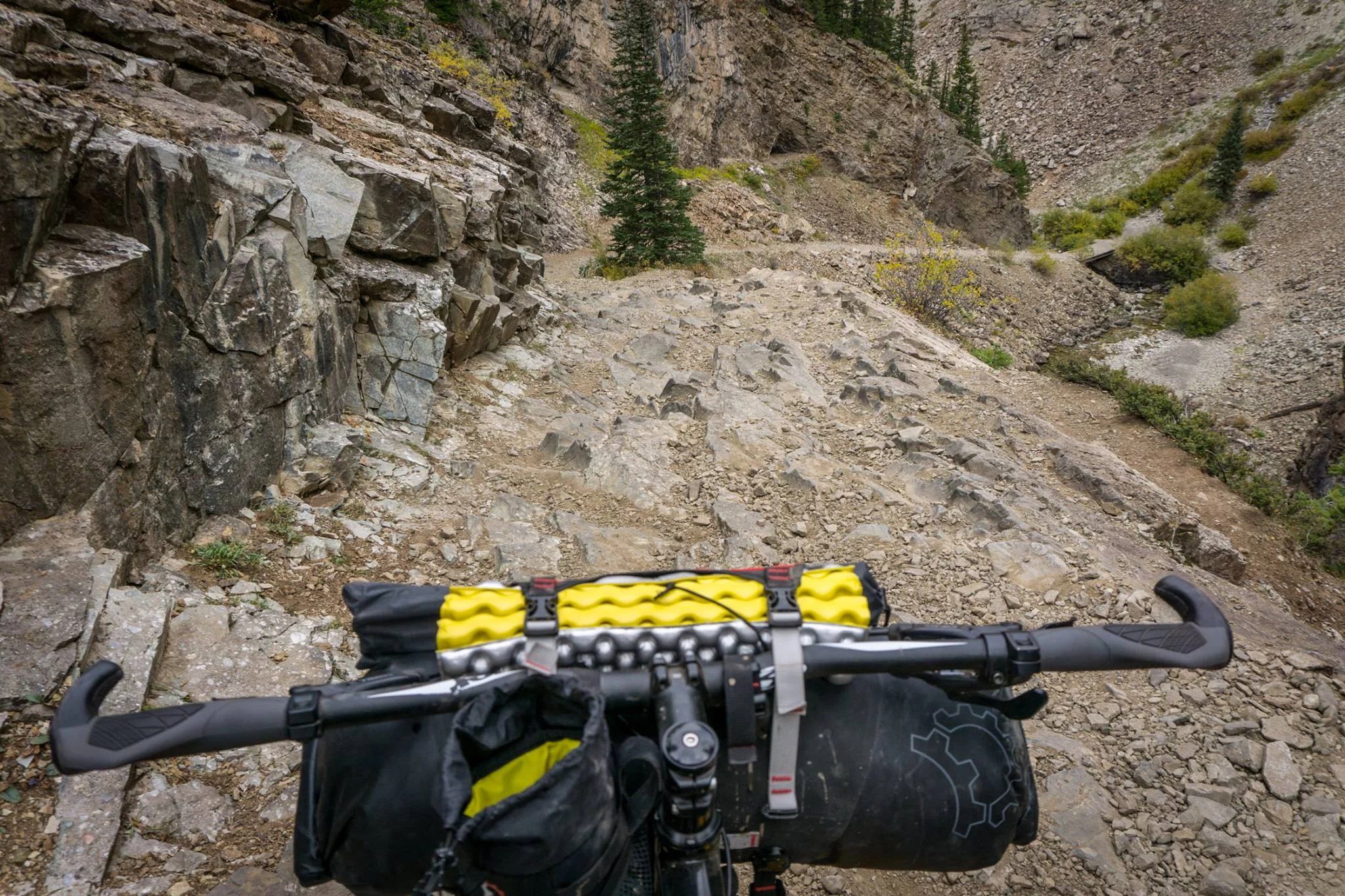 Simple cockpit before I got a fancy phone mount and wireless speaker. Headed down Schofield pass in Colorado. That foam dooohickey is a fold up seat, which I ended up using 0 times, but they come in hand during colder months to prevent freezing your butt off.
