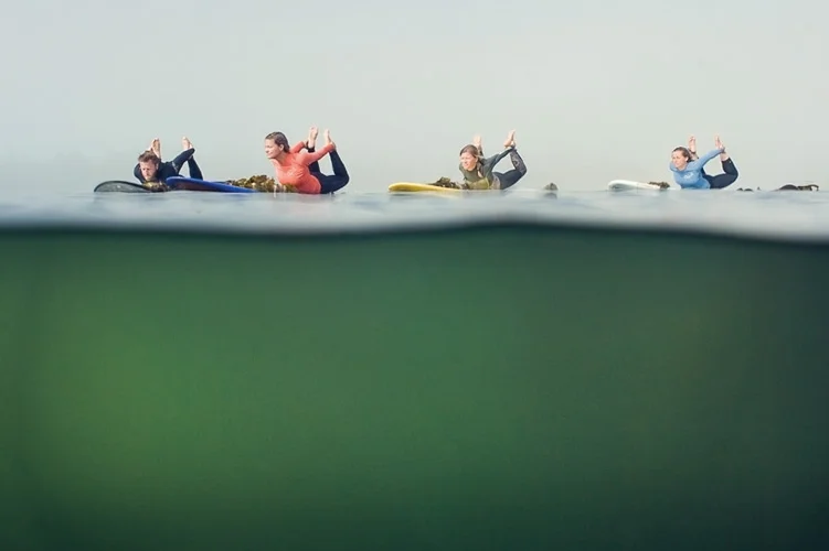 Group of friends practicing yoga on SUP's in Tofino