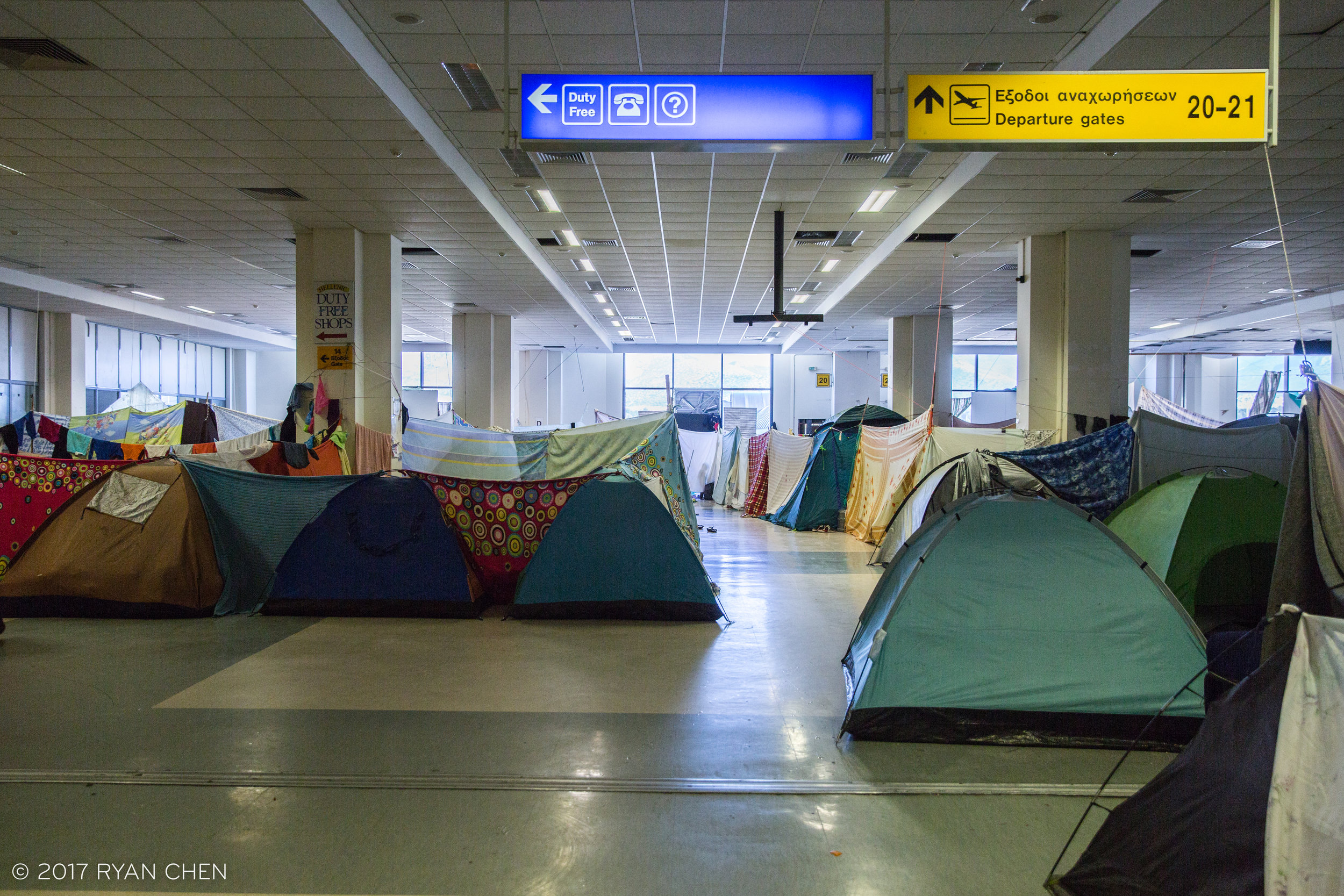 Unable to work in Greece or find legal ways to get into other E.U. nations, Afghan refugees find themselves stuck in miserable conditions of Elliniko camp. Ironically this encampment is located in the departure hall of the former Athens Airport.