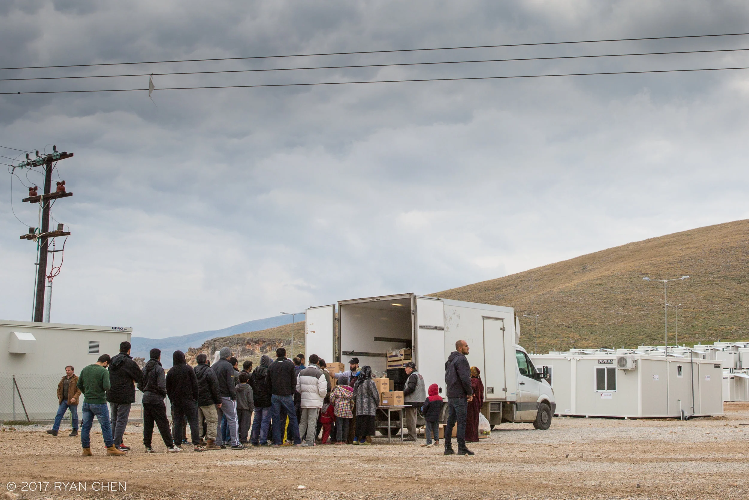 Syrian and Iraqi refugees line up for rations at Koutsochero camp.