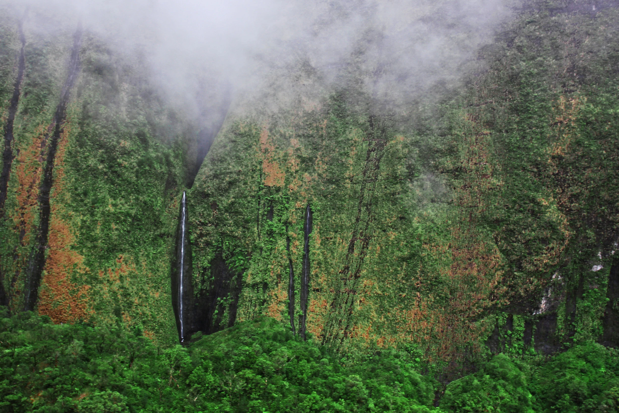 Mountains laced with threads of waterfalls 