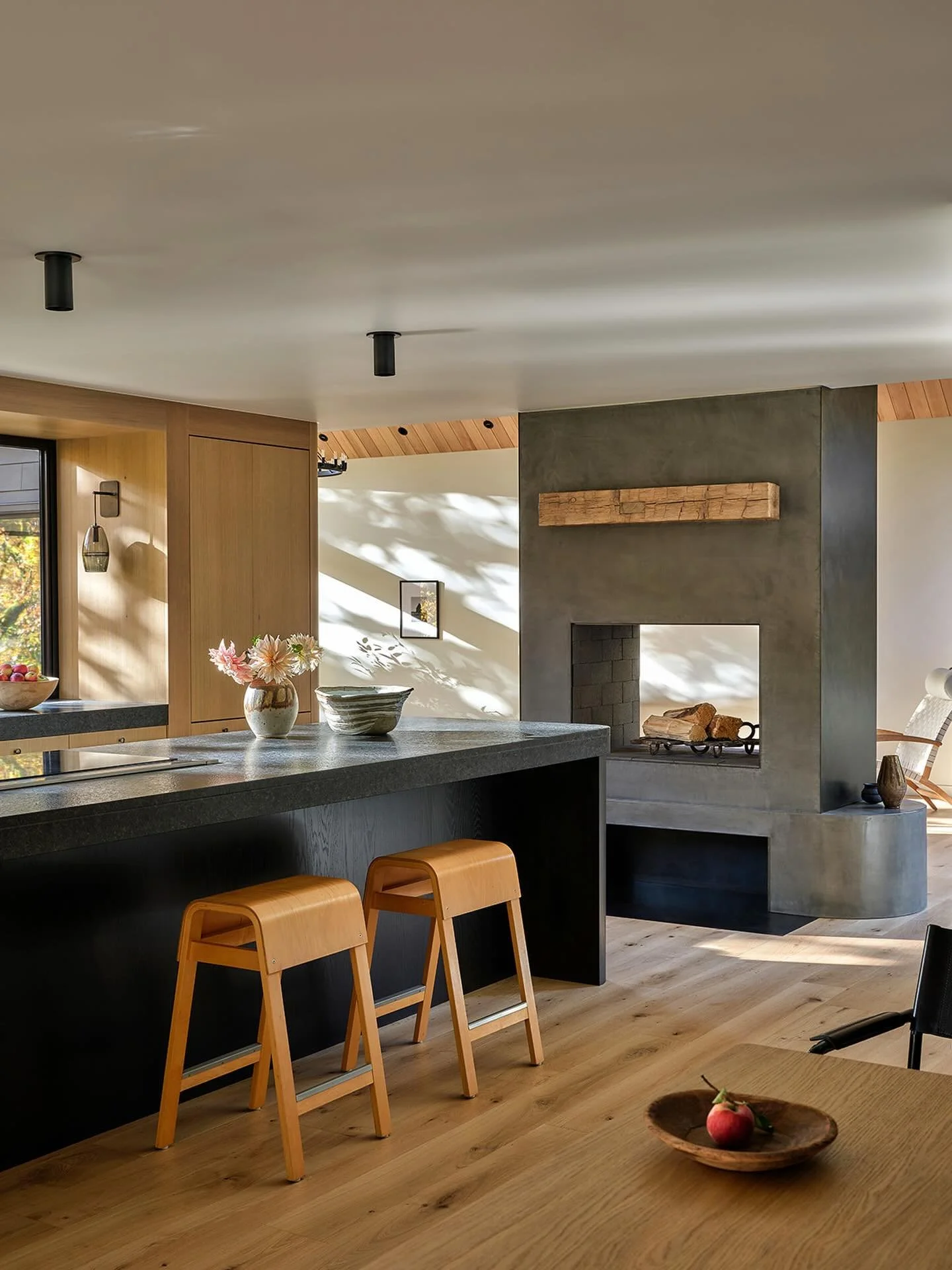 The hearth is located in the heart of Sockeye&rsquo;s re-worked floor plan.  The wood burning fireplace can be enjoyed from both the kitchen and living room, while providing a defining edge to both spaces. 

Architecture and Interior Design @thegugge