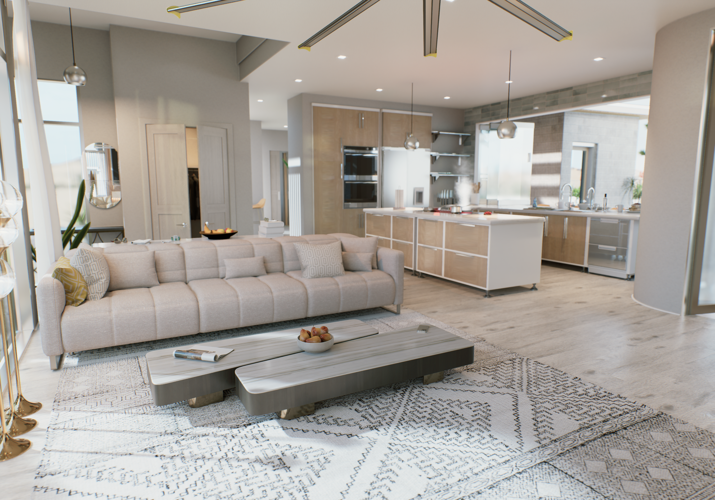 Modern open-concept living room with a beige sofa, a patterned area rug, and a coffee table with a bowl of apples. Visible kitchen area with white and wood cabinetry, stainless steel appliances, and large windows letting in natural light.