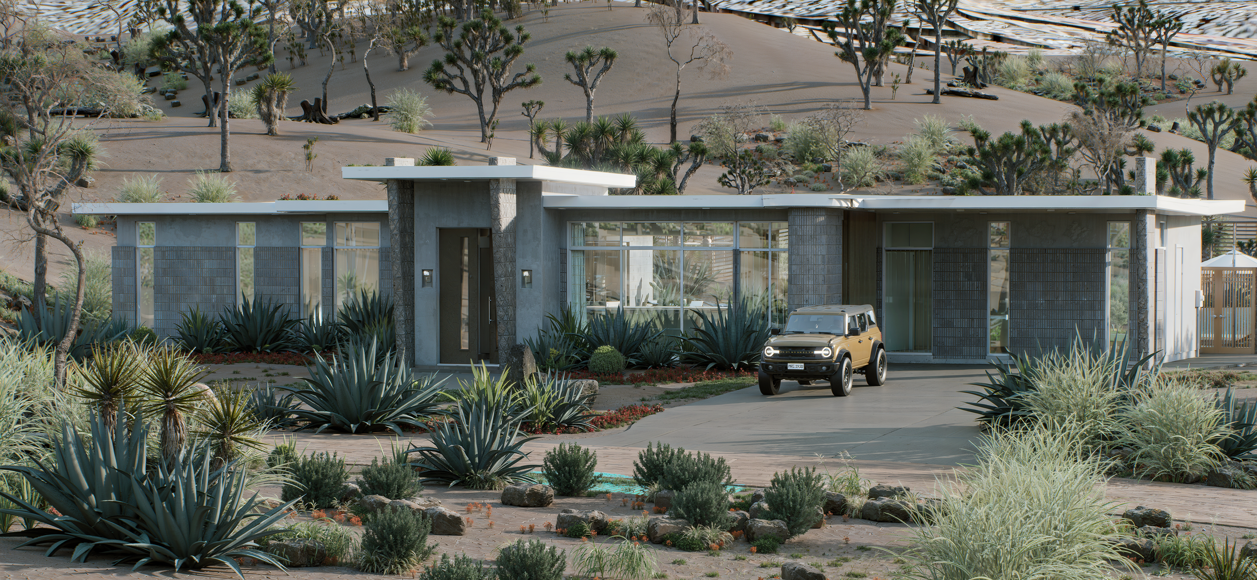 Modern single-story house with large glass windows, surrounded by desert plants and trees, with a tan vehicle parked in the driveway, in a desert landscape with sandy hills and Joshua trees.