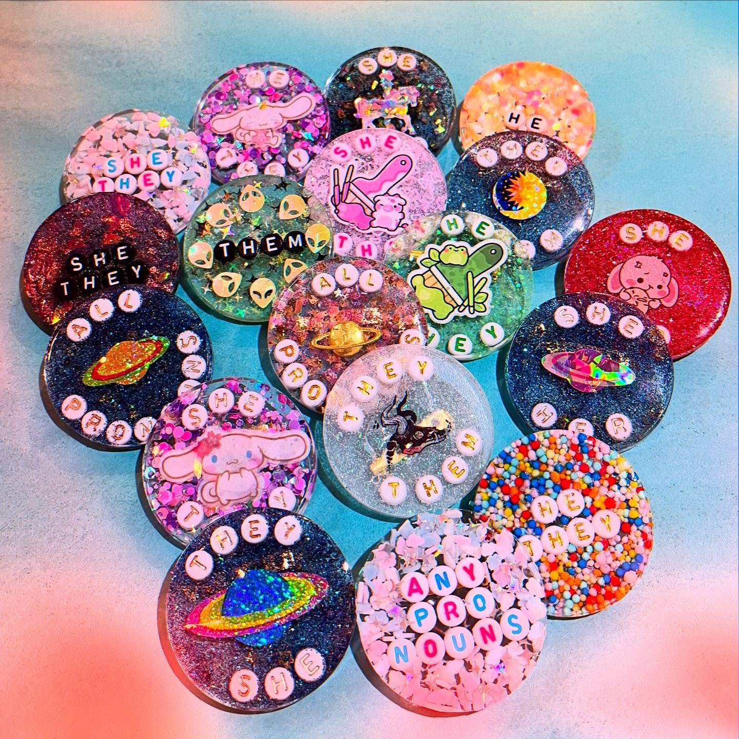 The very talented @artfuldodger2397 just restocked the pronoun resin pins and brought along some Best Dad ones too! They took a little break from resin but they&rsquo;re back in the studio. Yay! Our shop is cuter, sweeter, and more inclusive for it. 