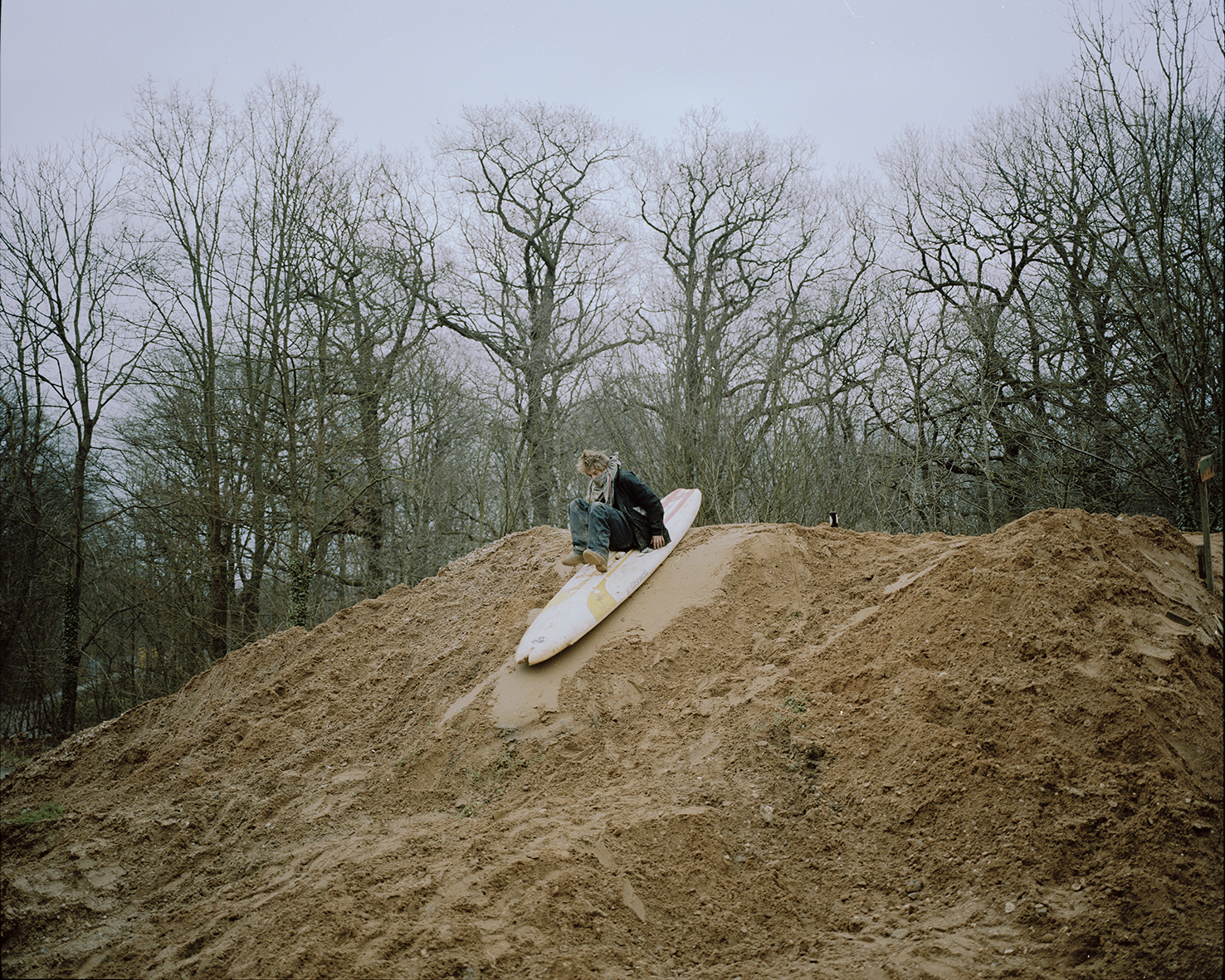 ‘Hole’ surfs down a hill of mud.