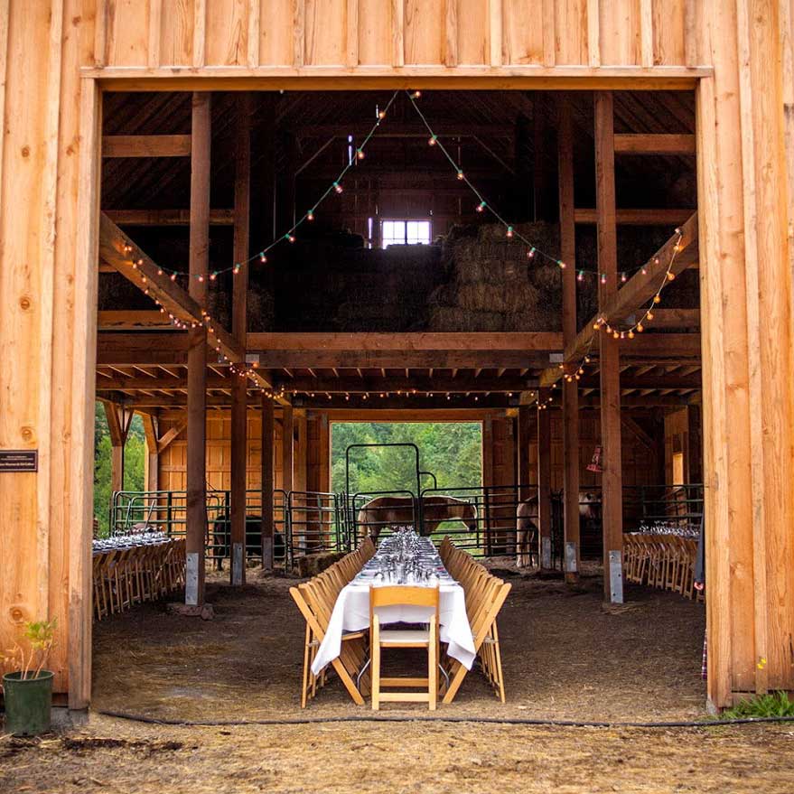  Big Table Farm Hay Barn with Family Style Dining Tables Set Up For An Event 