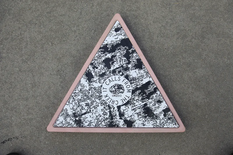 Concrete site marker. These markers referenced Department of Interior site markers, and also summoned darker powers.