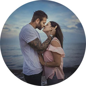 Couple kissing on the beach during their engagement photos