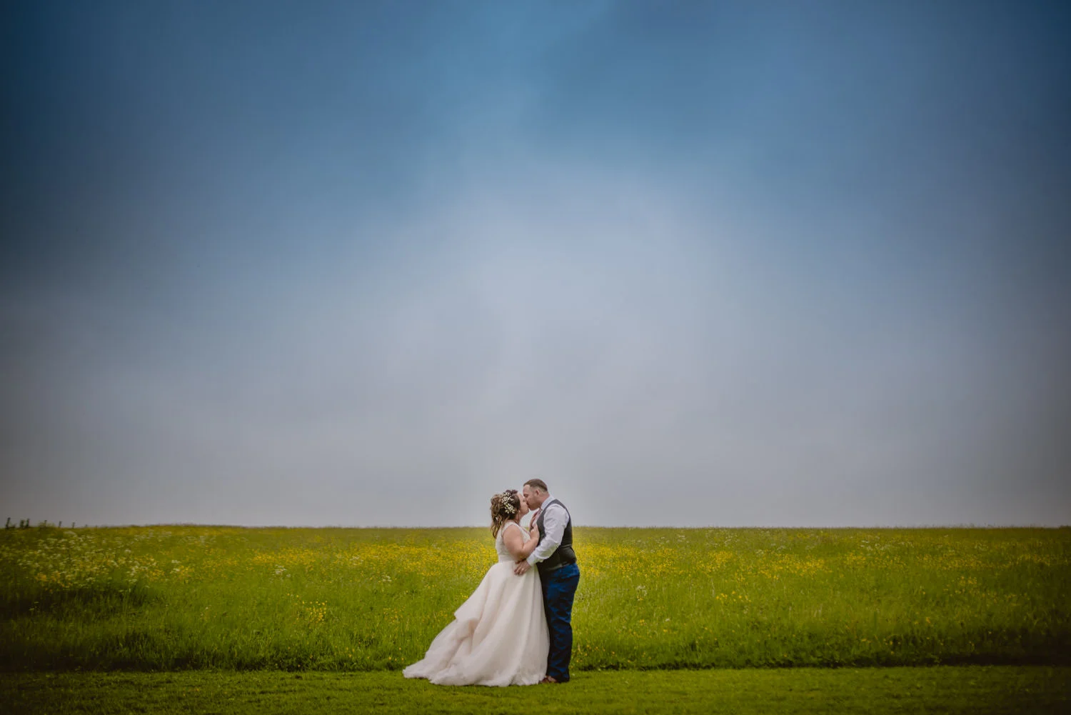 Portrait and creative photo of a married couple kissing at Cripps Barn during their wedding day