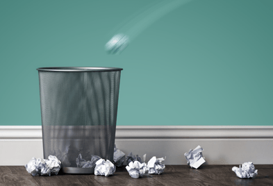 trash-bin-along-teal-wall-with-crumpled-paper (1).png