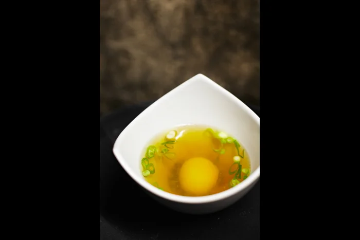 Ham broth, slow cooked egg yolk, spring onions, peas, potato chips
