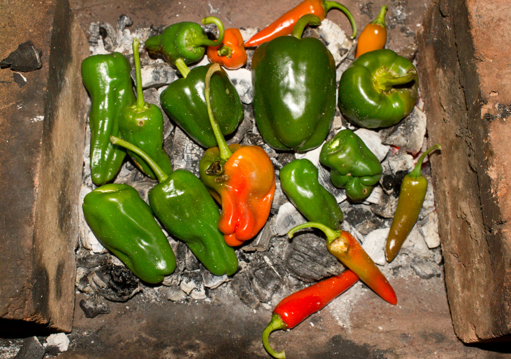  Charring peppers in embers 