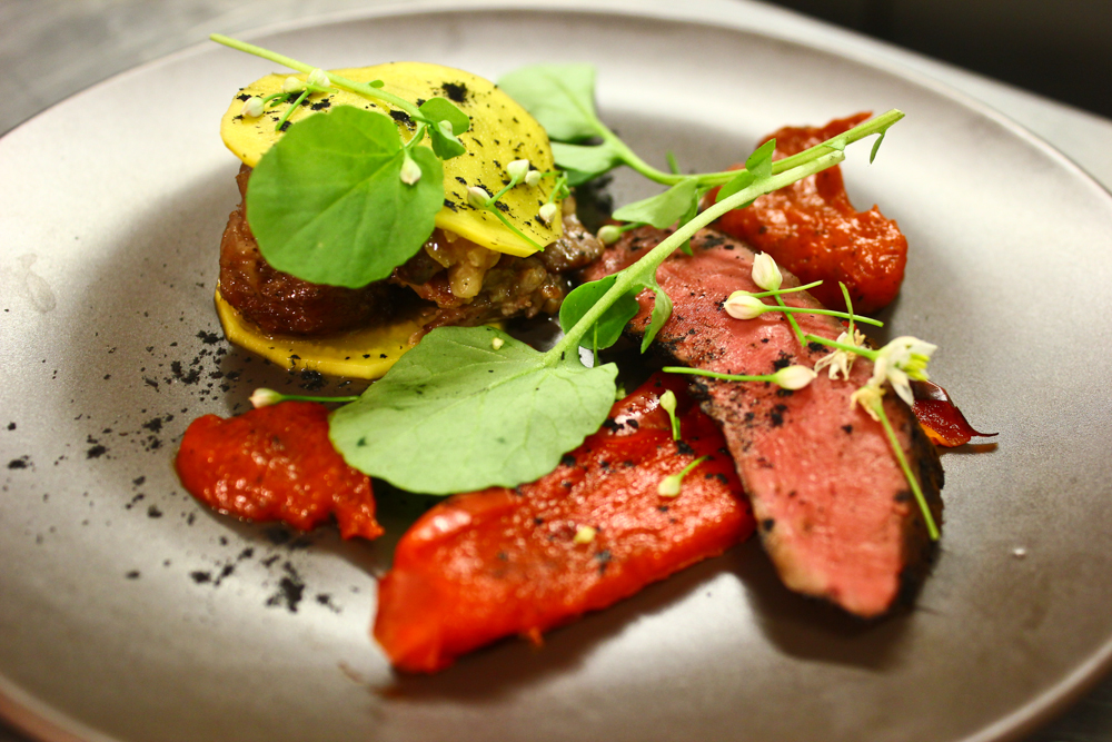 Grilled hangar steak and slow cooke oxtail, pickled beets, roasted peppers, land cress