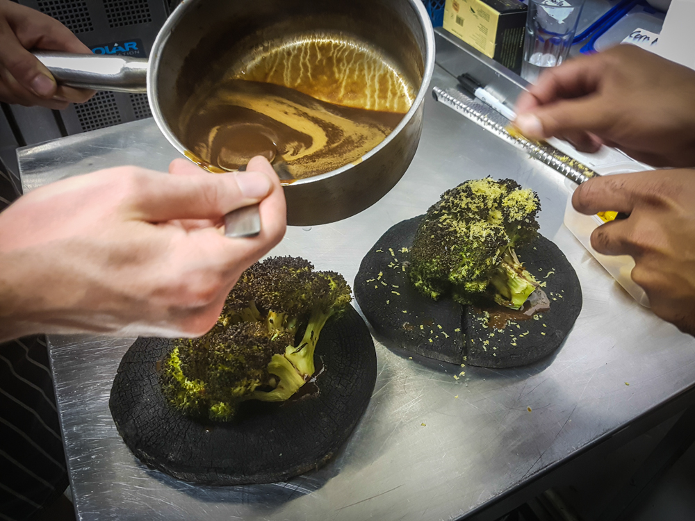  Shaving cured egg yolks over roast broccoli 