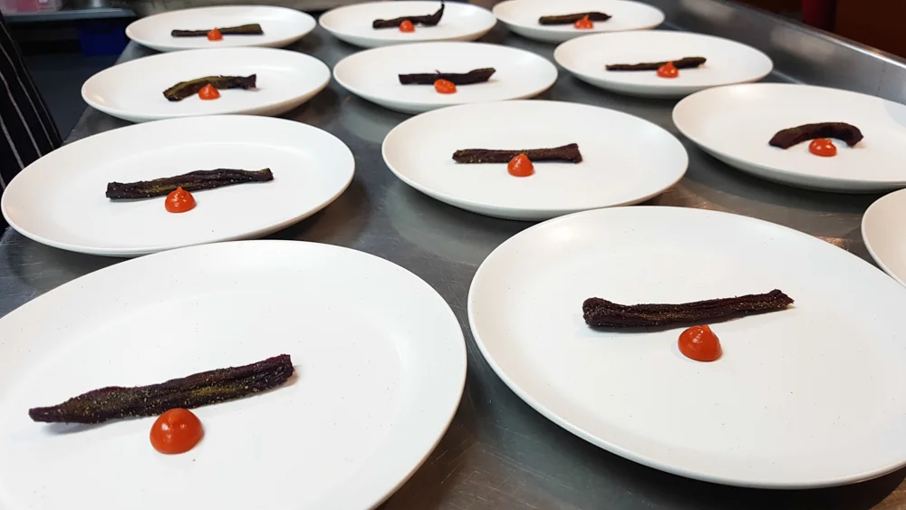  Beetroot, baked, dehydrated and poached in beetroot juice and dill pickle brine. Dried dill pickle and a blob of beach rosehip paste 