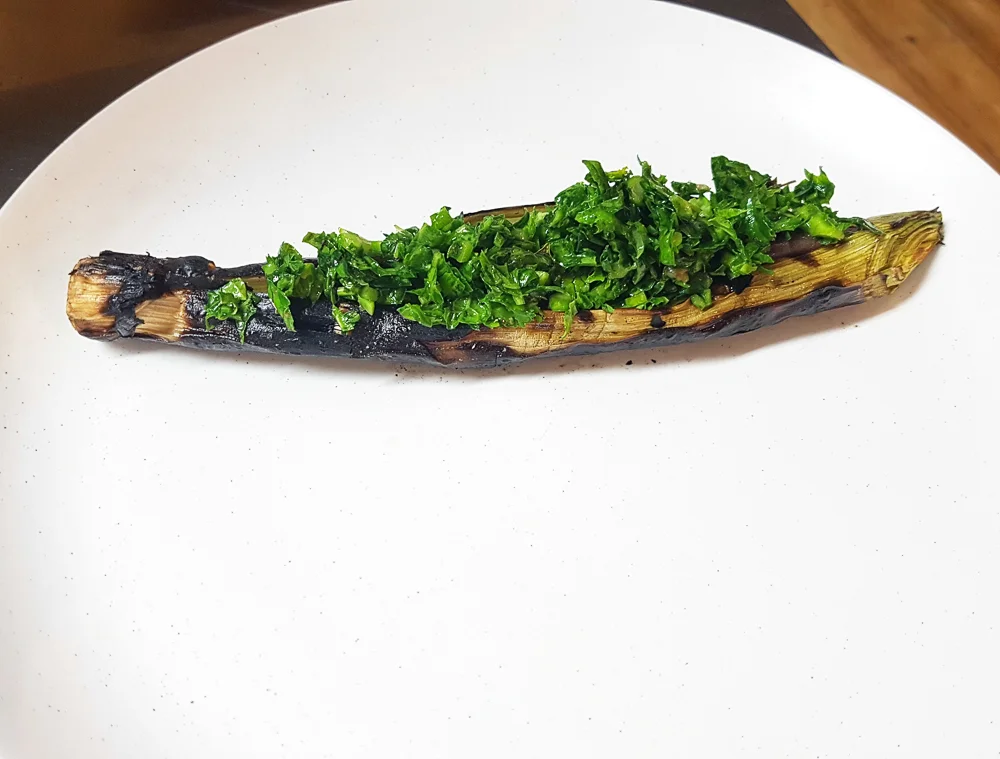  Barbecued leek, fermented and roasted mushroom paste, and salad of black mustard, pickled ramson buds and tarragon 