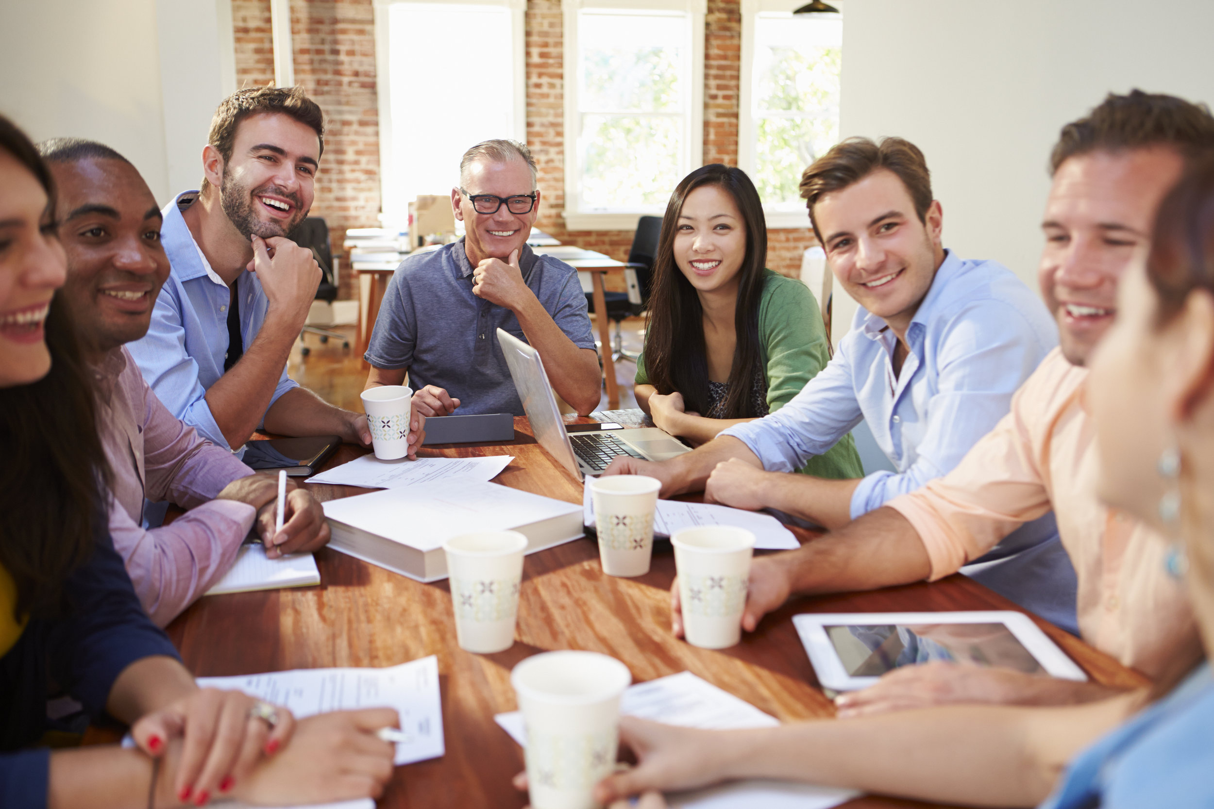 shutterstock_290589185 team at table.jpg