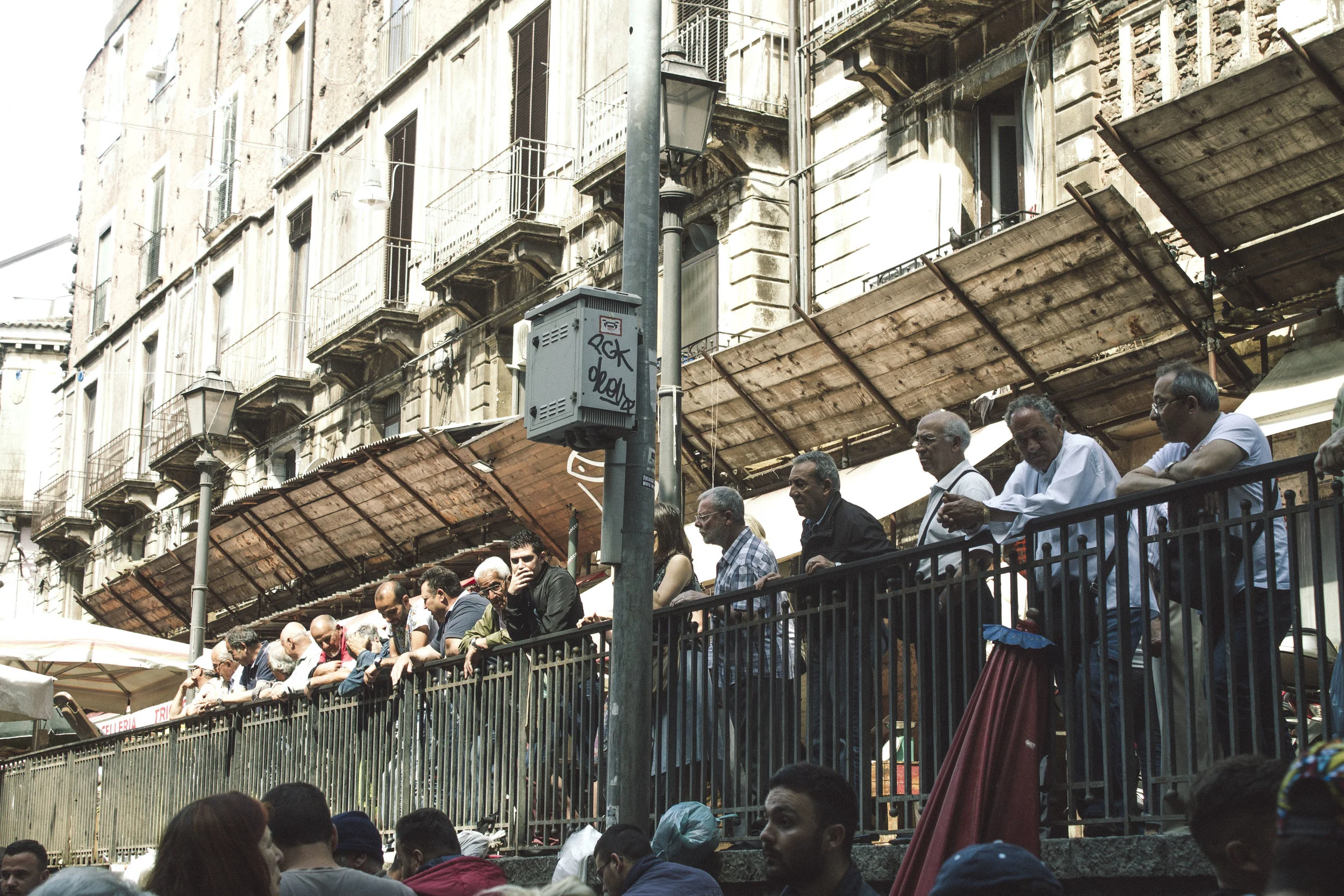 Locals watch the spectacle that is Catania's fish market