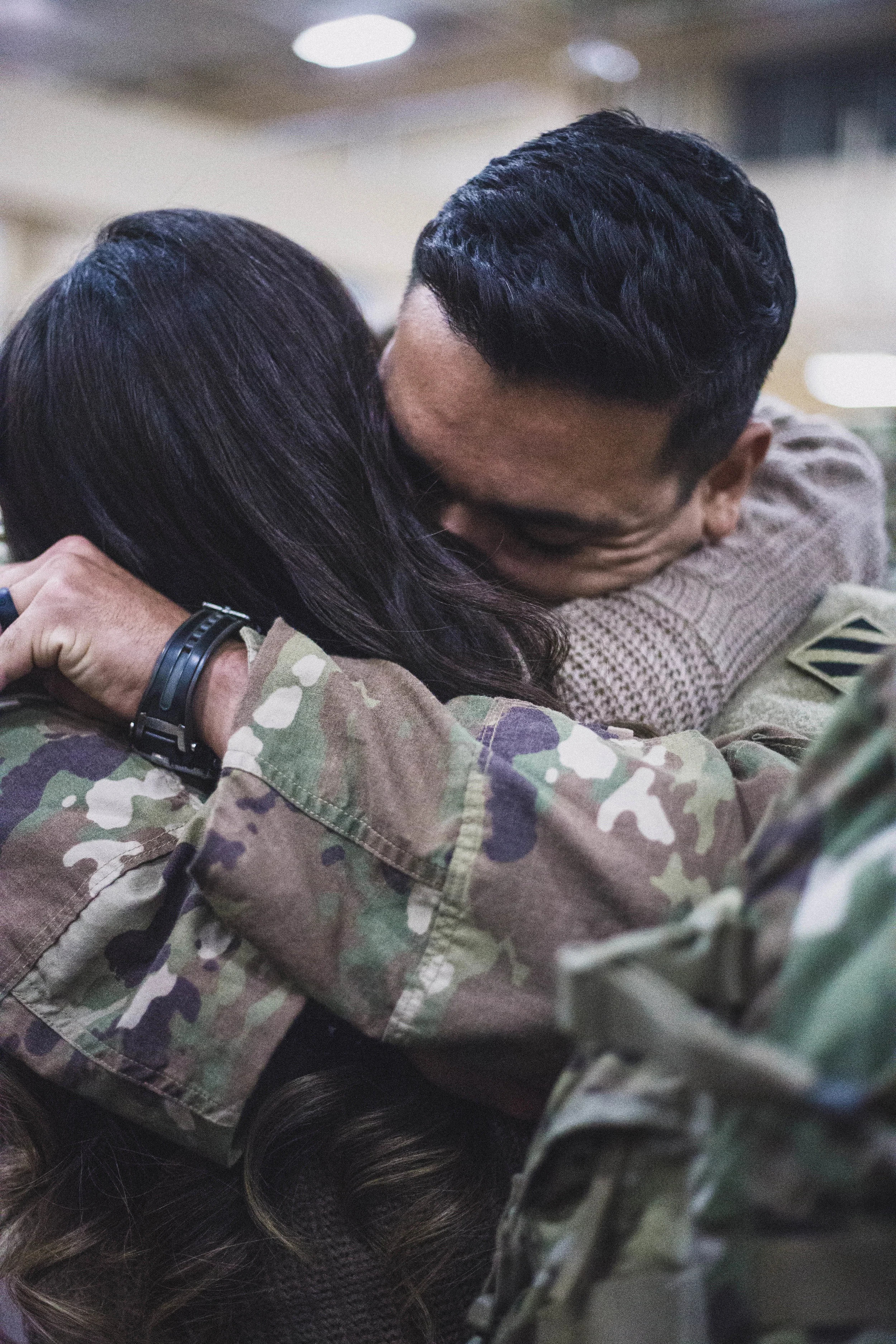 Husband and wife embrace for the first time when he returns home from nine months in Afghanistan