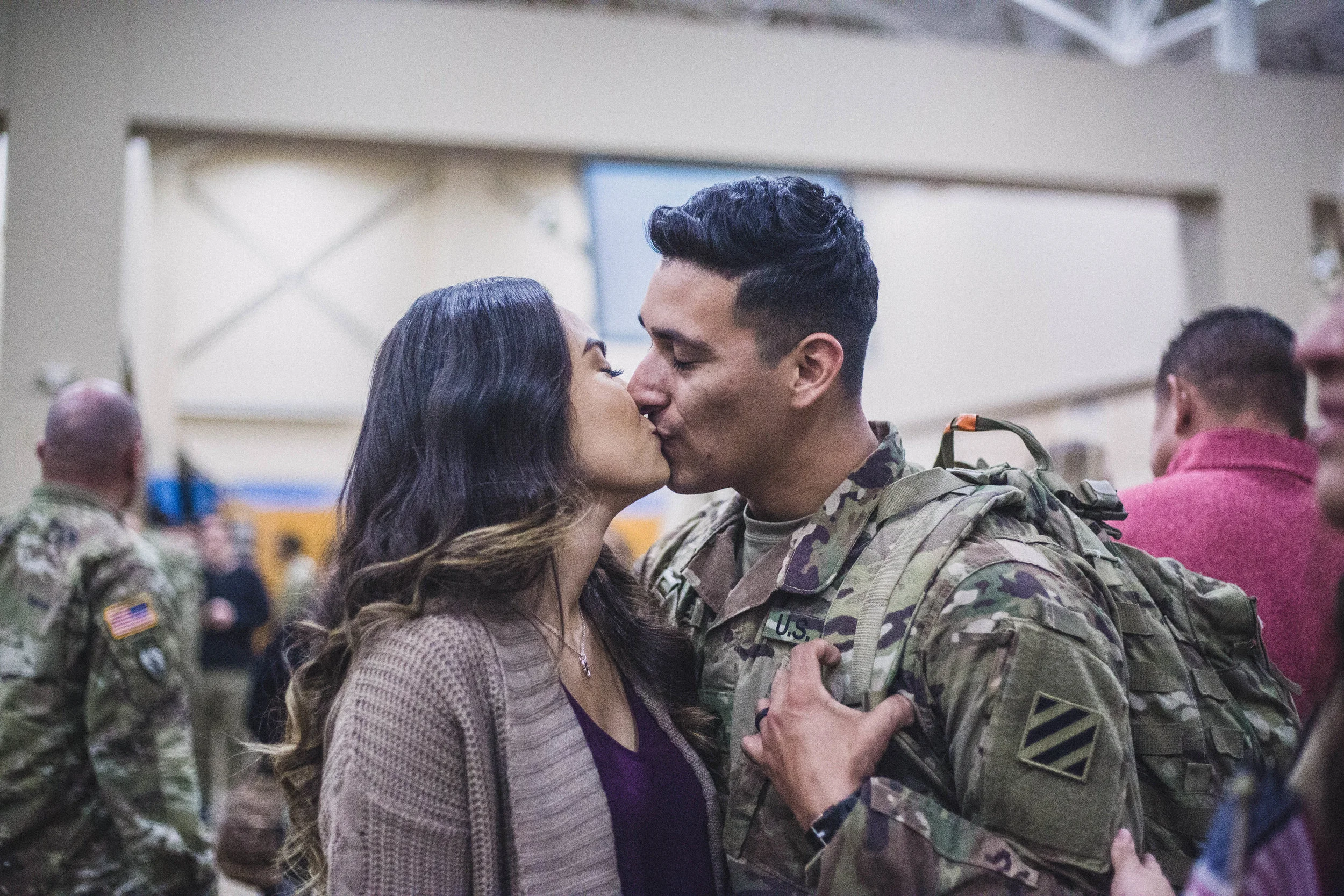 Husband and wife kiss for the first time after he returns home from nine months in Afghanistan