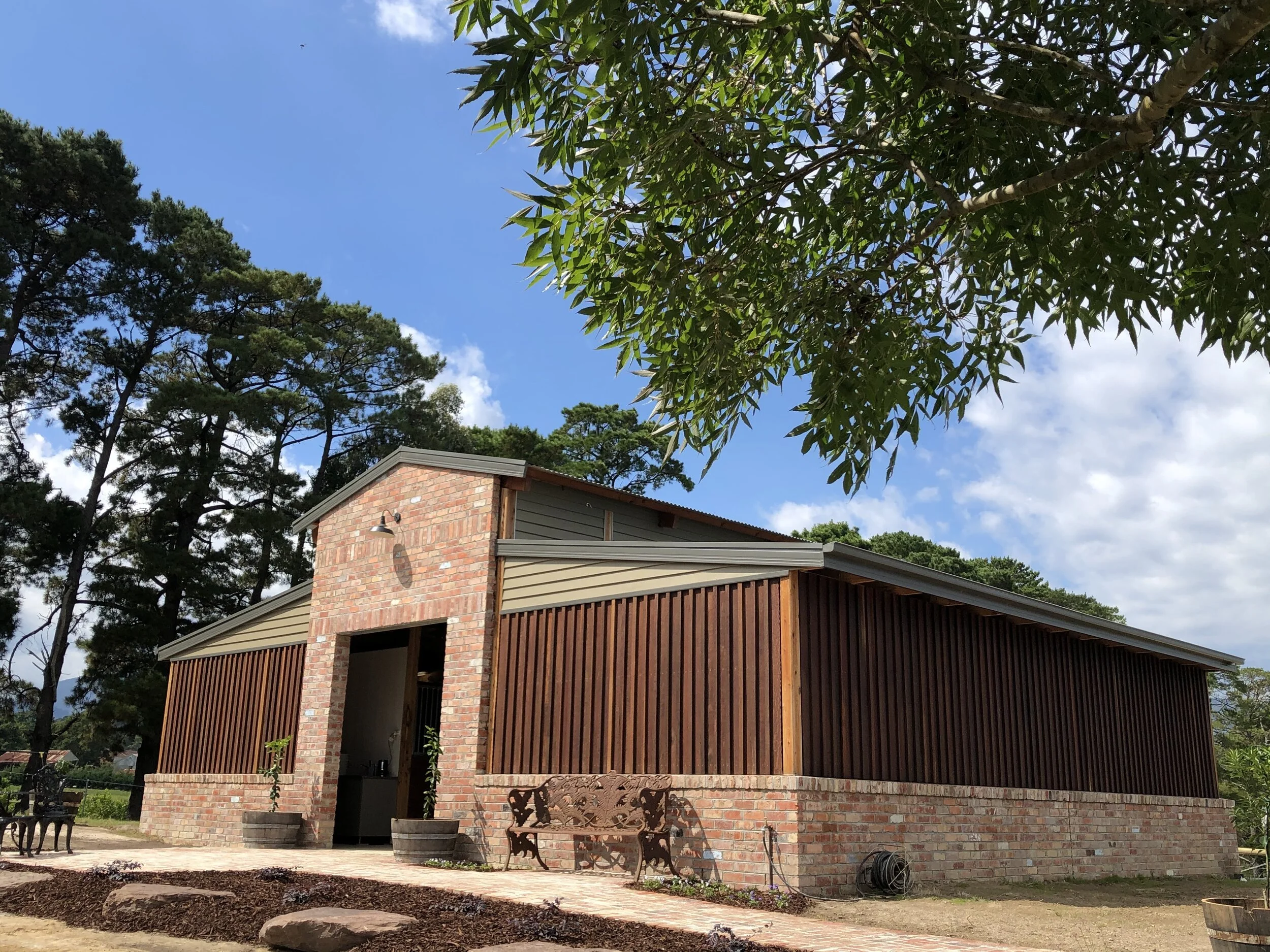 custom horse stables constructed of recycled bricks and ironbark cladding