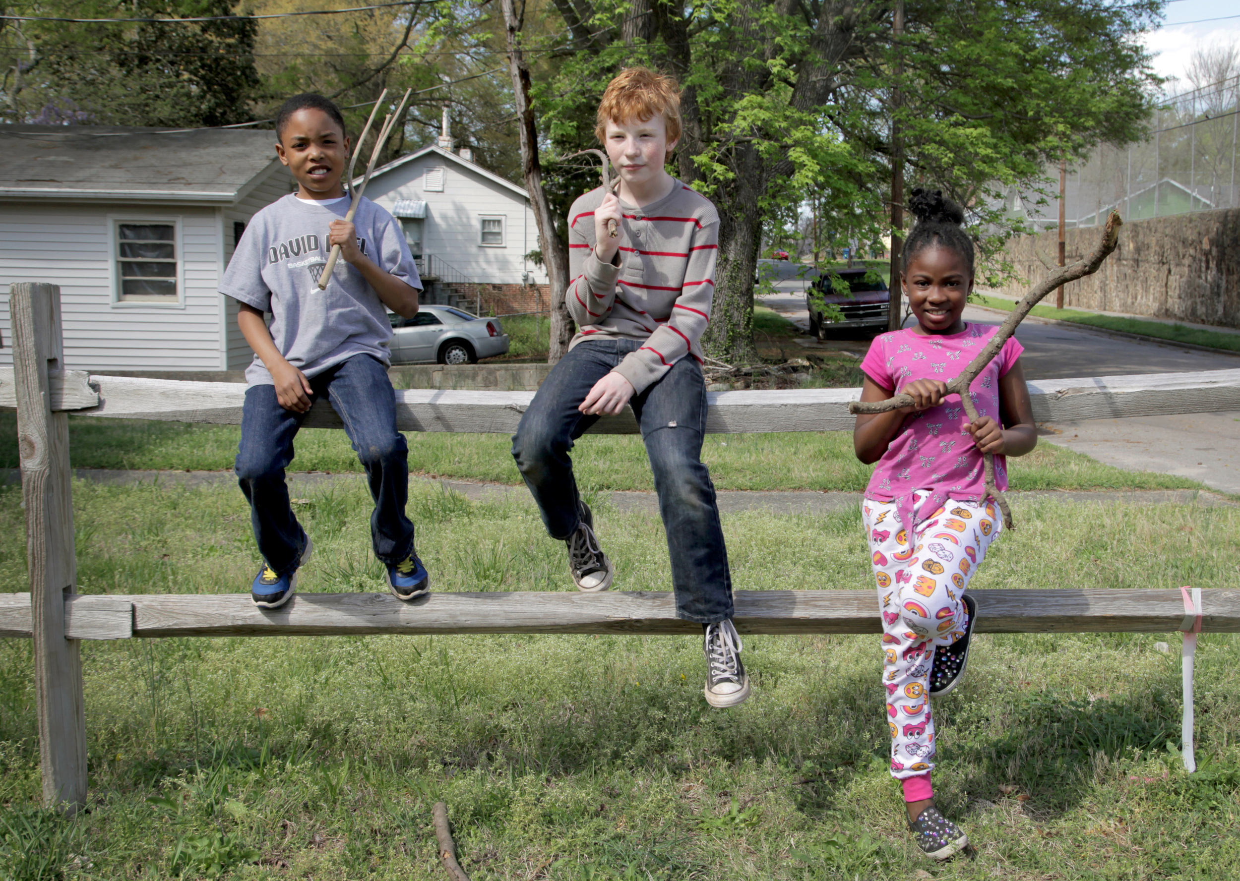 The Blackjack Club sit on the fence that separates 409 and 411 North Maple Street in Old East Durham. On a sunny spring day in March, all three are touting the sticks they’ve named and are using to train each other for self defense, and for use in their made-up game—Sweeper.