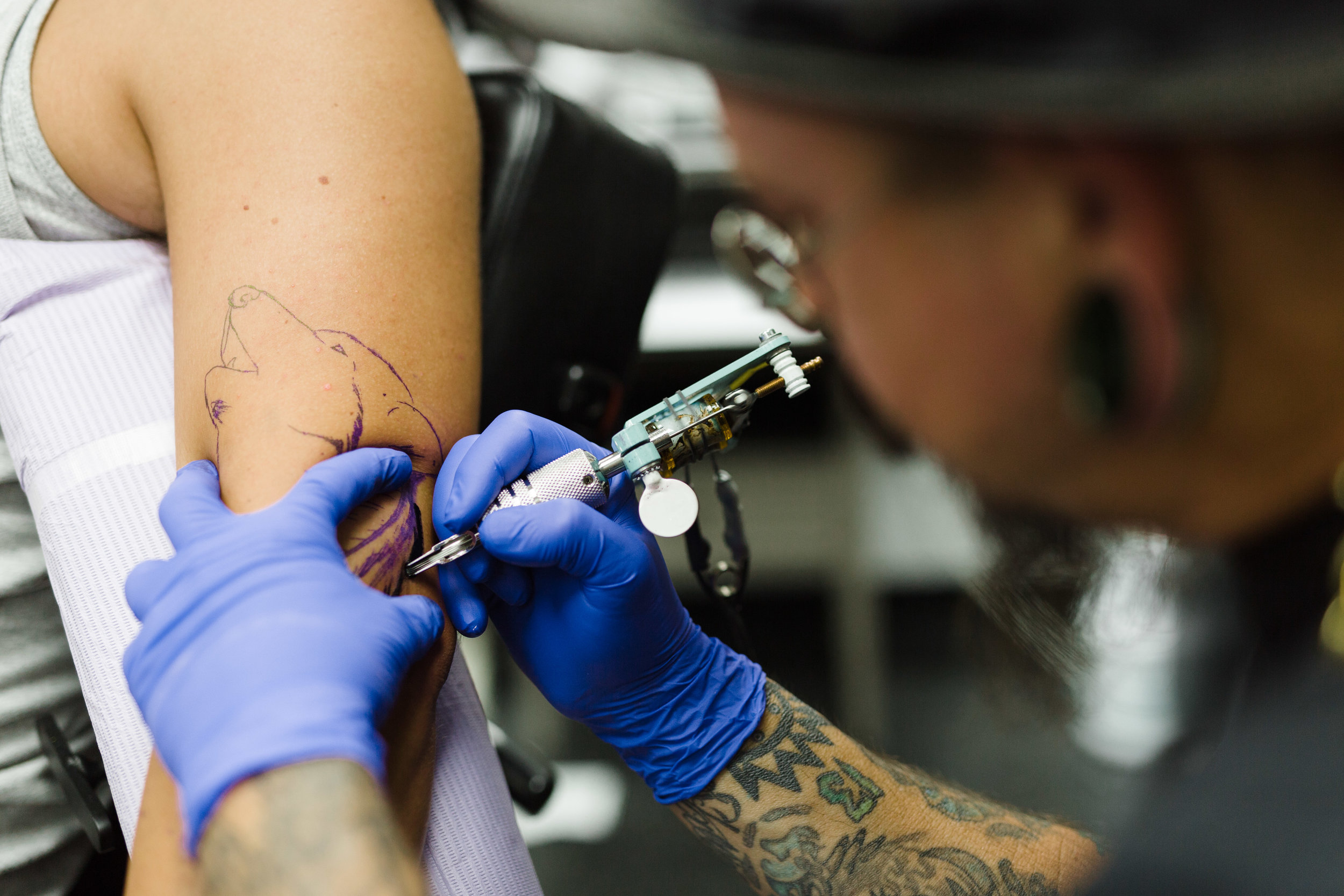 Mike tattoos an homage to his client's native american roots, a wolf with feathers