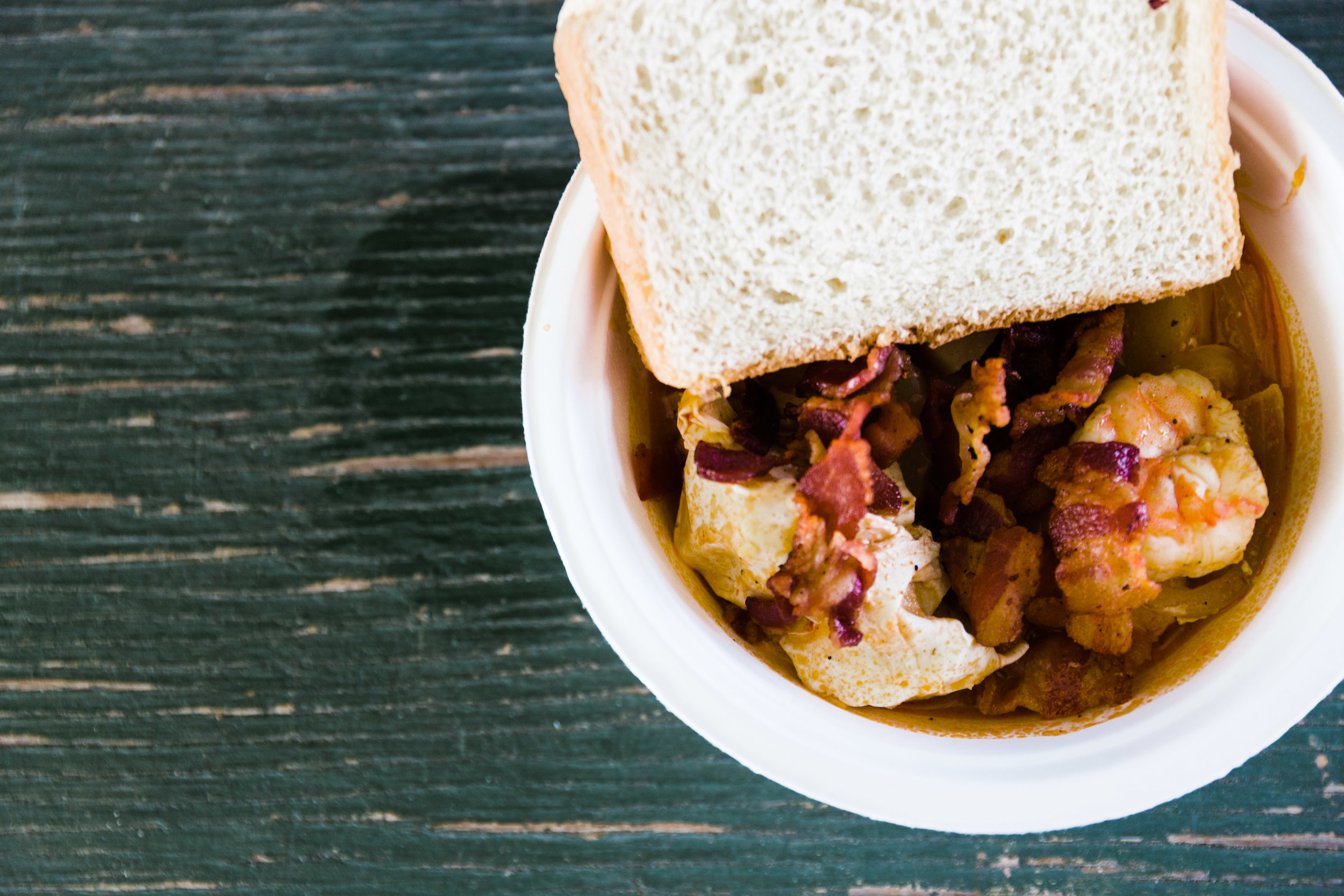 Shrimp Stew with poached egg, white bread and bacon