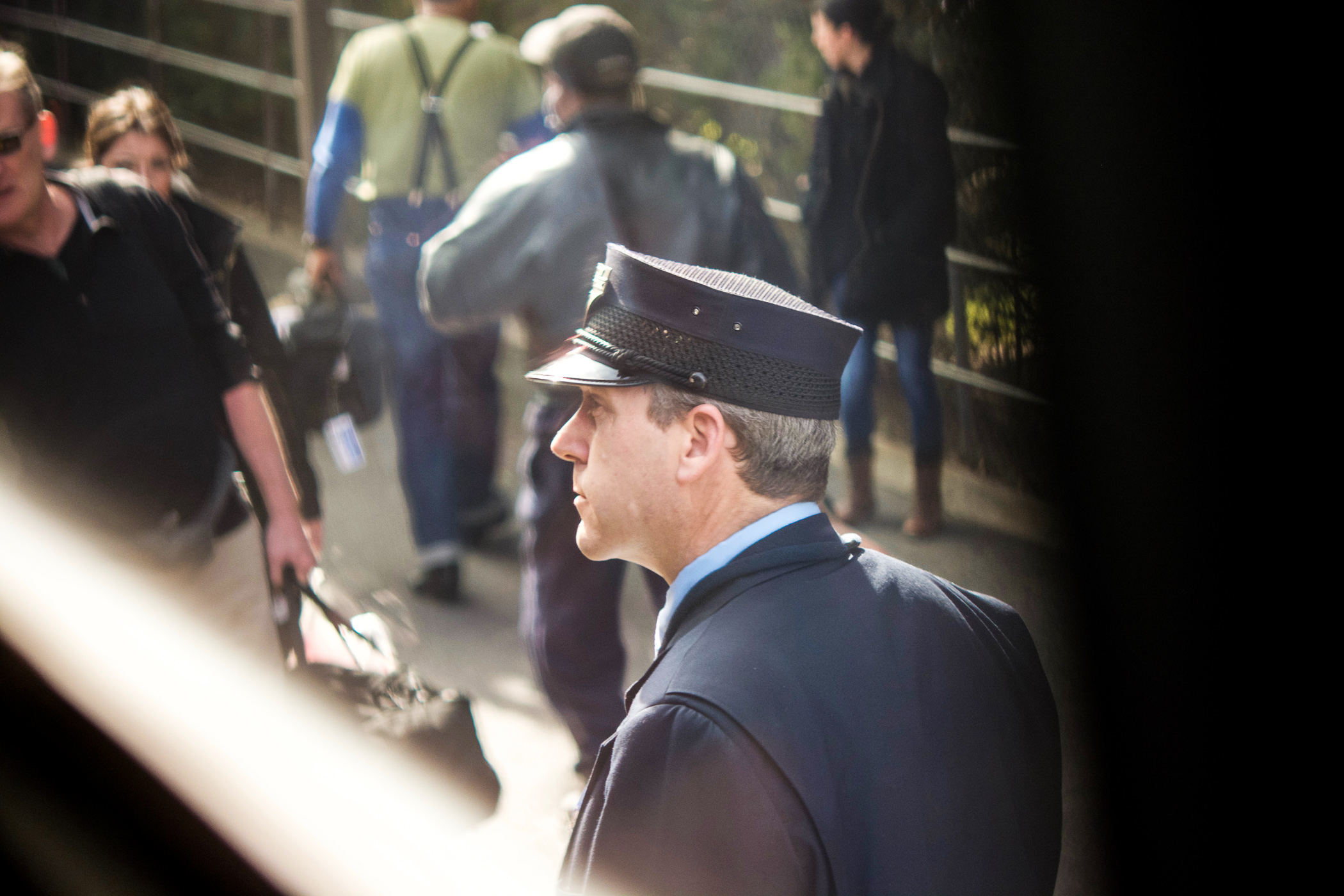  Amtrak conductor assisting passengers boarding train at Durham station. 