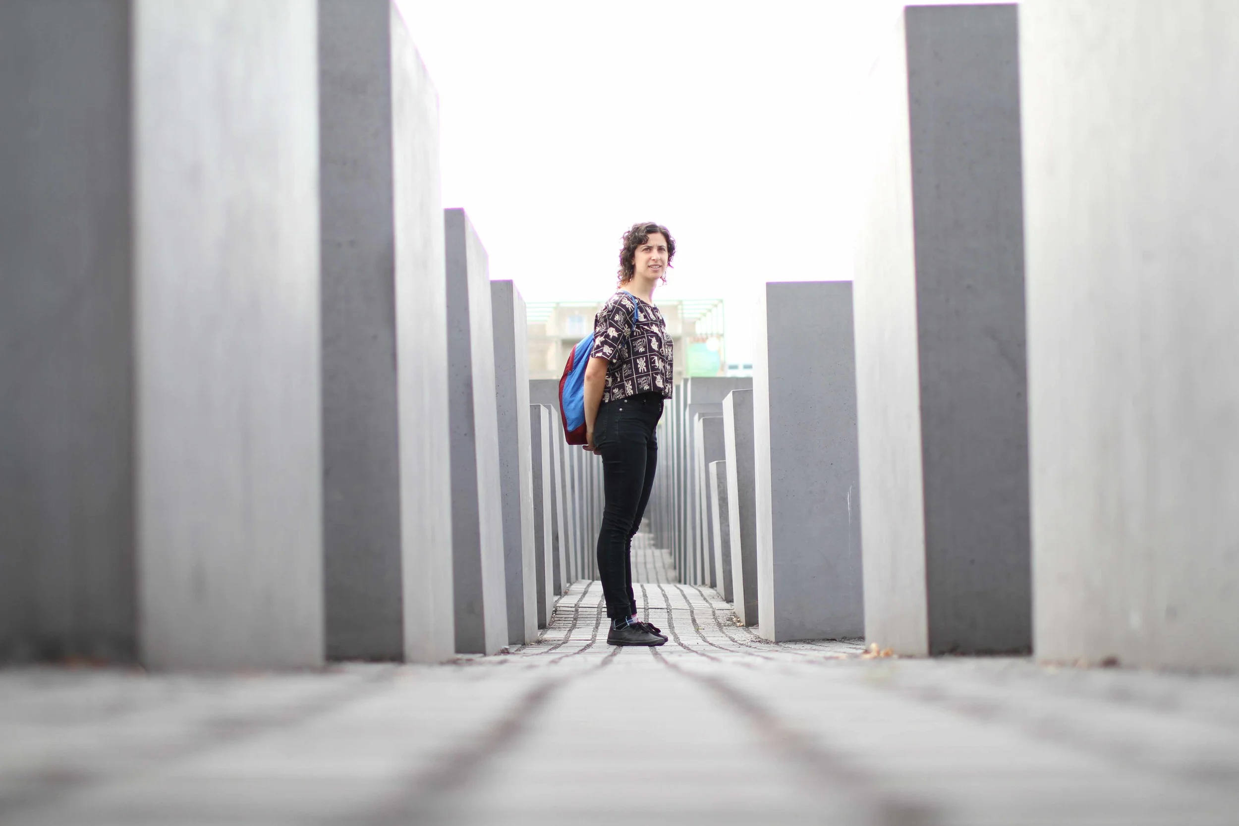 Standing in the Memorial to the Murdered Jews of Europe in Berlin. Meant to mimic grave stones, and erected in unending rows, you are forced you to move through the columns alone, meditating on the inconceivable horror of the Holocaust. —