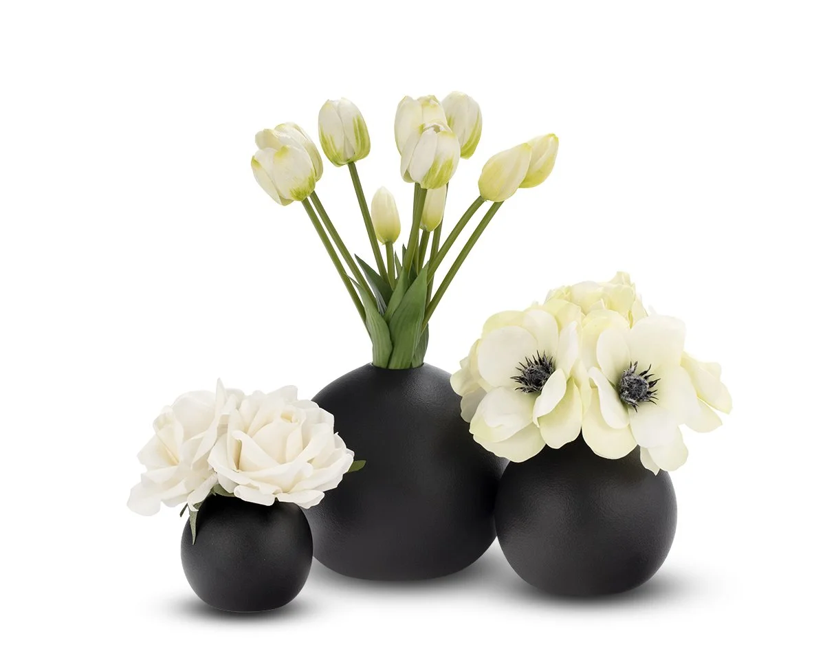 White artificial flowers in black bowls