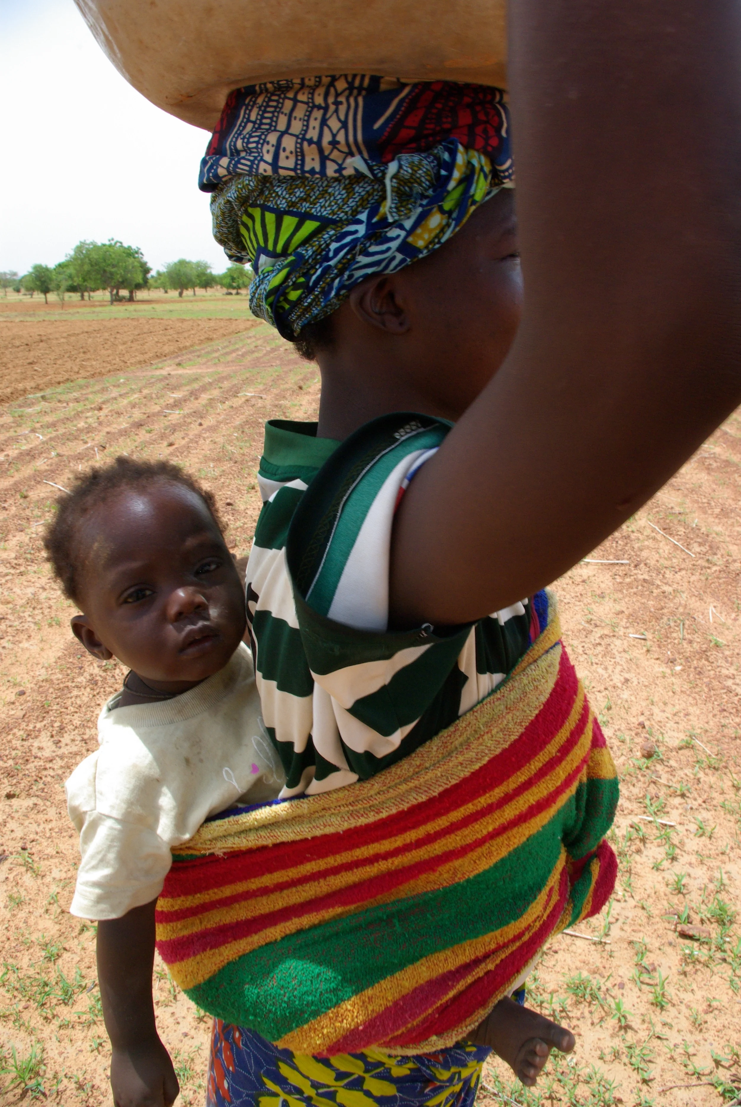 Woman carrying water with baby.JPG