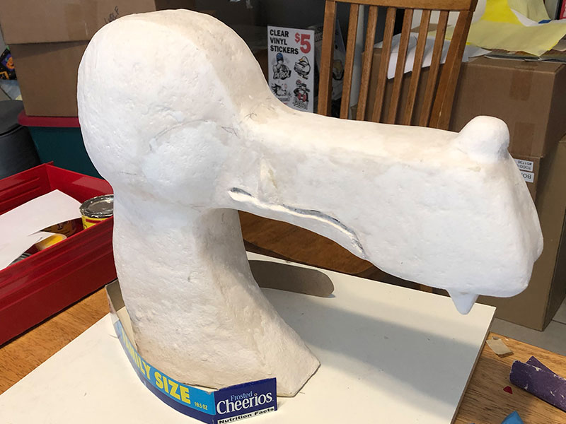 After many layers of Celluclay, the sculpture was sanded, more material added and sanded again. Repeat. Cardboard was then used to shape the collar.