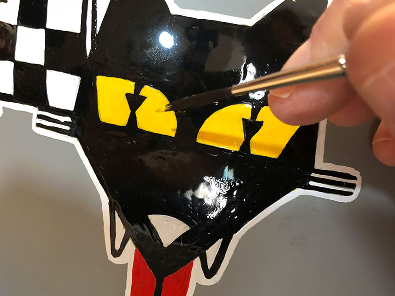 While the sculpture was drying, I was painting the “wolfy” details on the helmet. Each design was based on real racing logos, except changed to show a wolf theme (Wulf racing, Carnivore spark plugs, Lupine stereo, etc.)