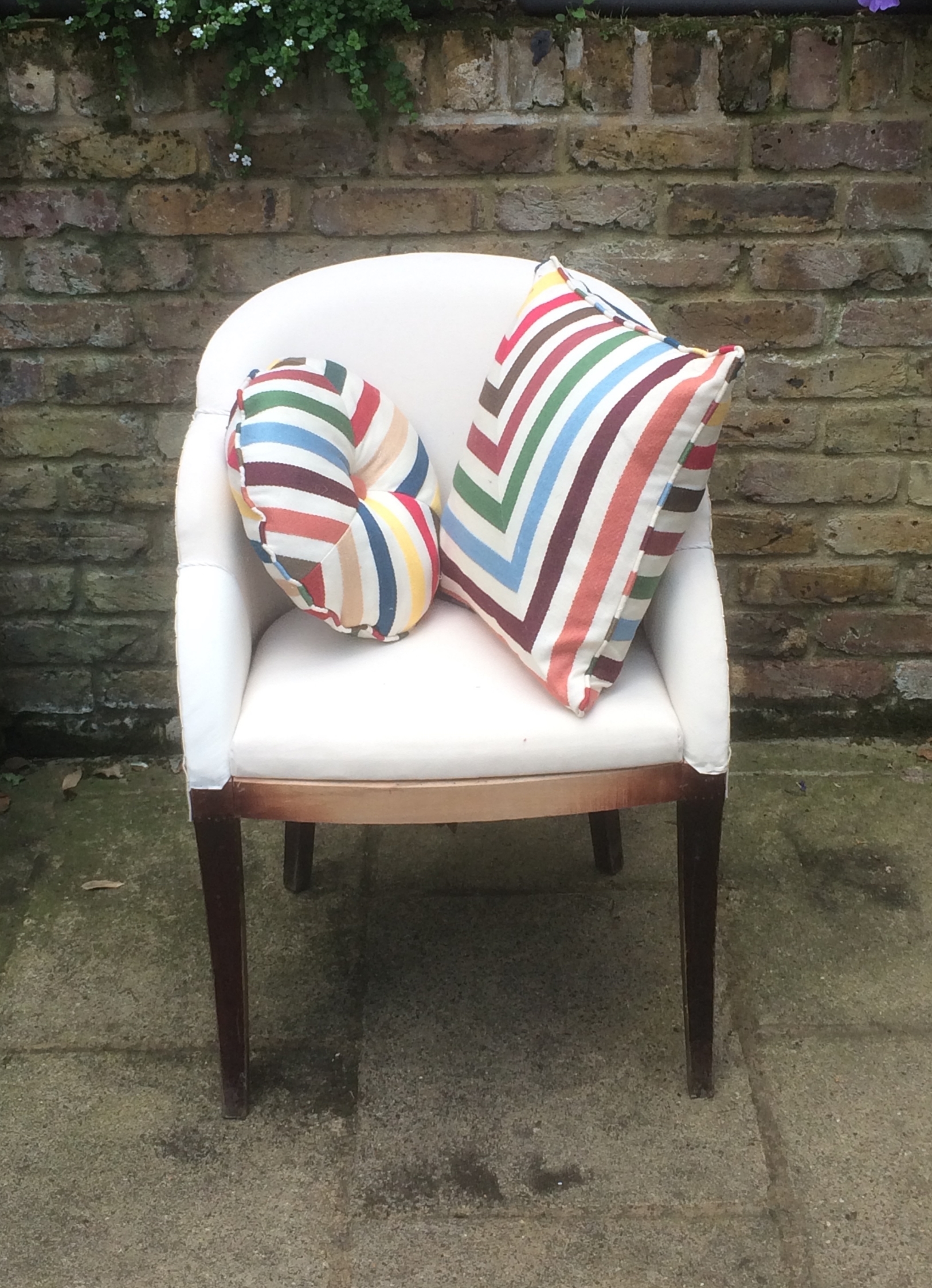 This scalloped armchair is reupholstered and ready for your choice of top fabric Fun stripy cushions to brighten up an old sofa!