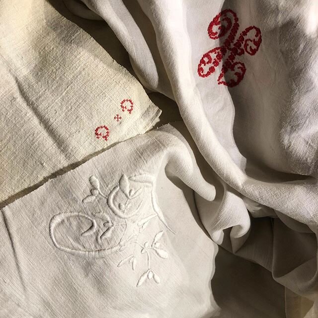 Close-ups of two loose covers made for a sofa using antique linen sheets- with their beautiful ornate or simple original monograms. #upholstery #loosecover #antiquelinen #monograms #renewdontbuynew