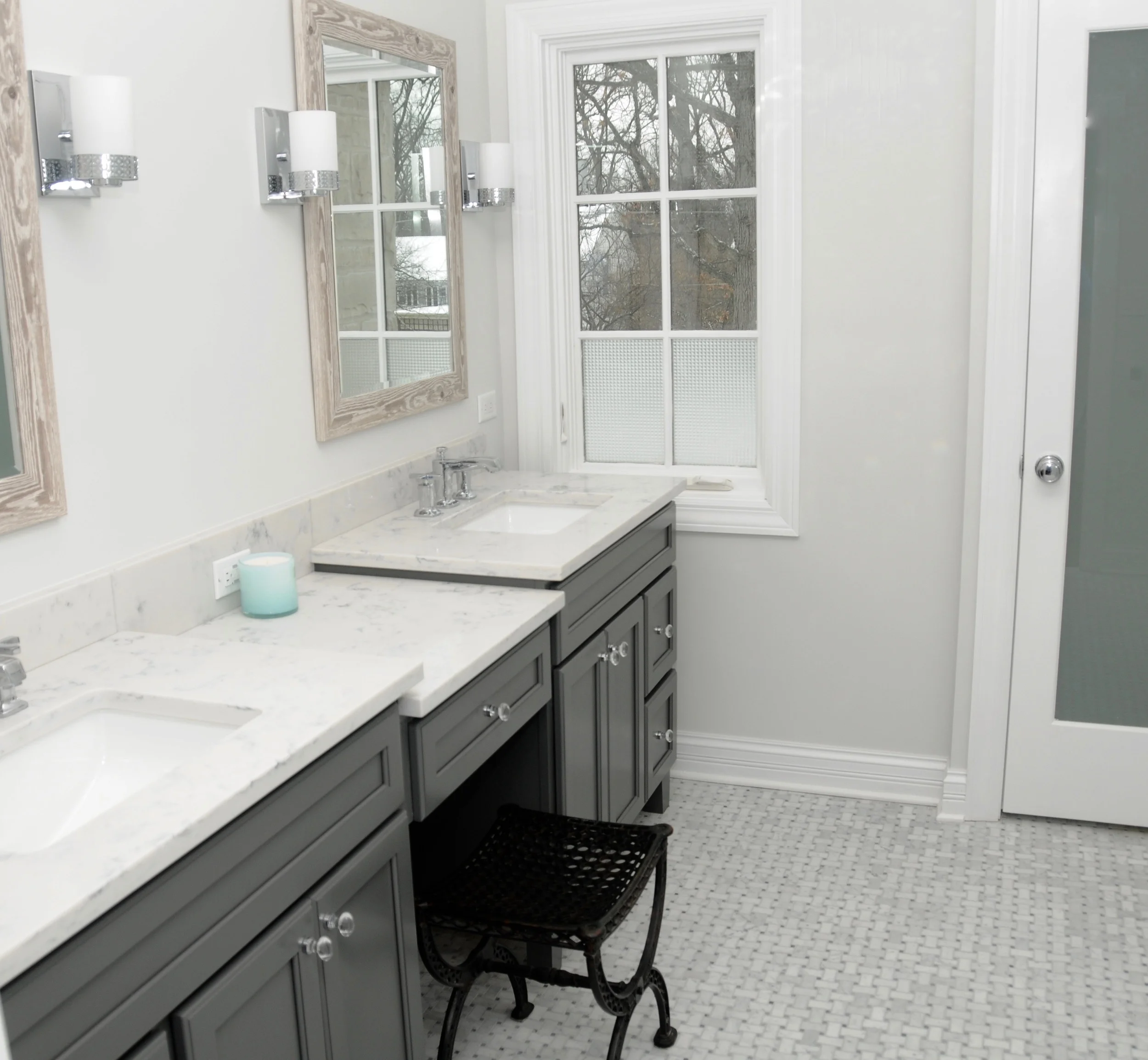We added storage with a double vanity and desk and enclosed the toilet in its own room behind a frosted glass door for privacy. 